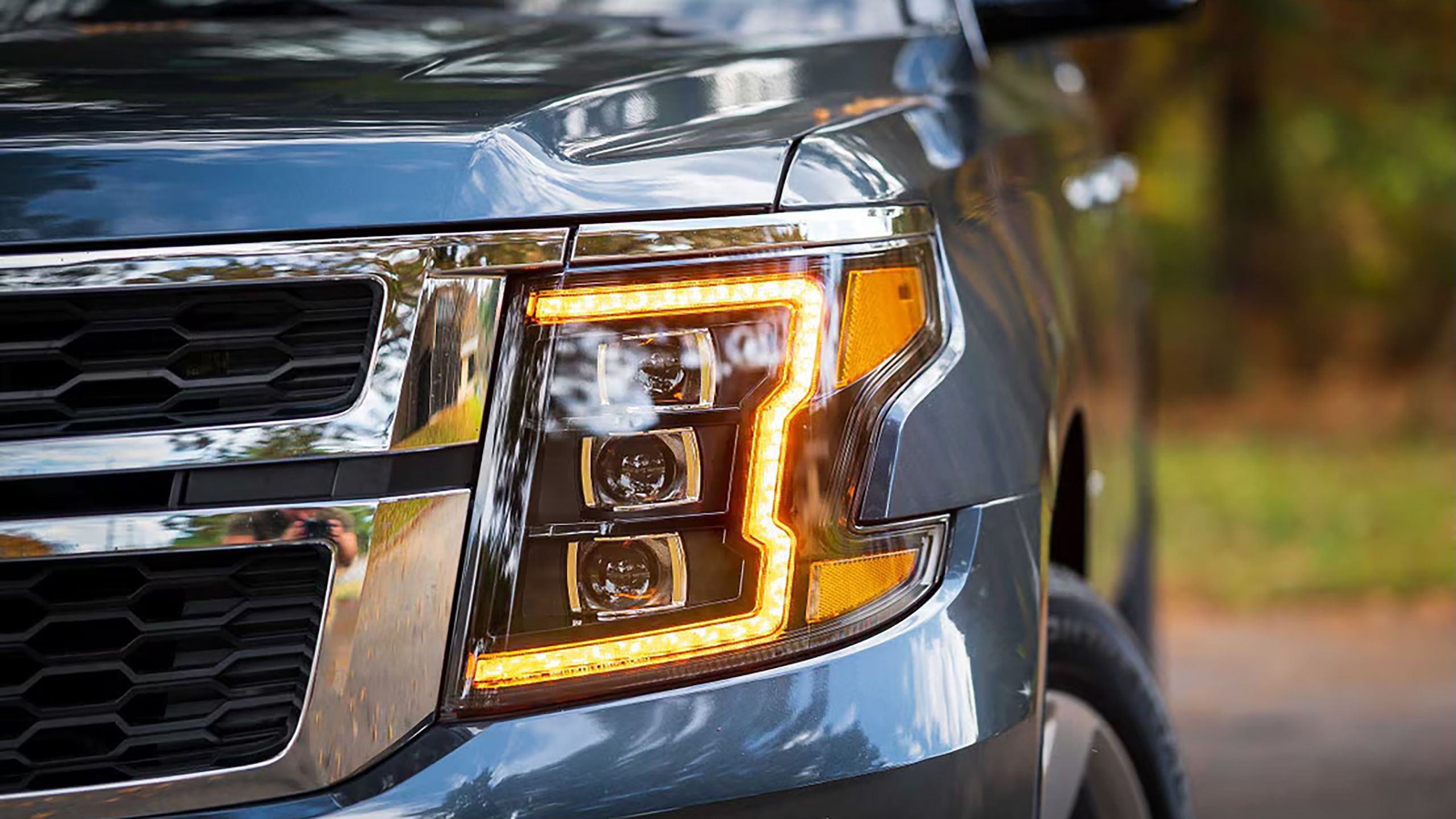 A set of Morimoto headlights mounted in a Chevrolet Suburban. 