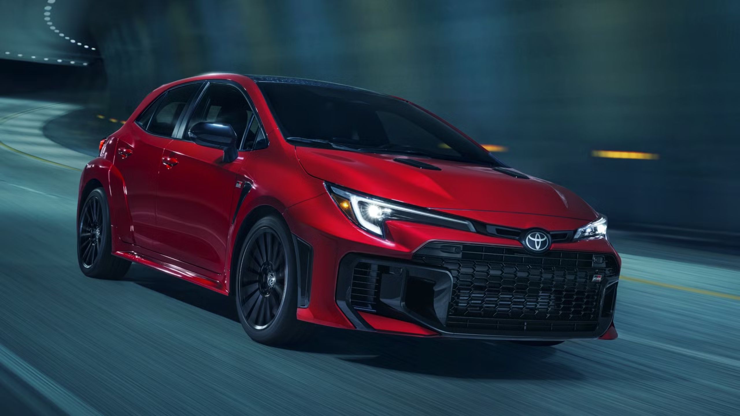 Front quarter view of the Toyota GR Corolla driving through a tunnel.
