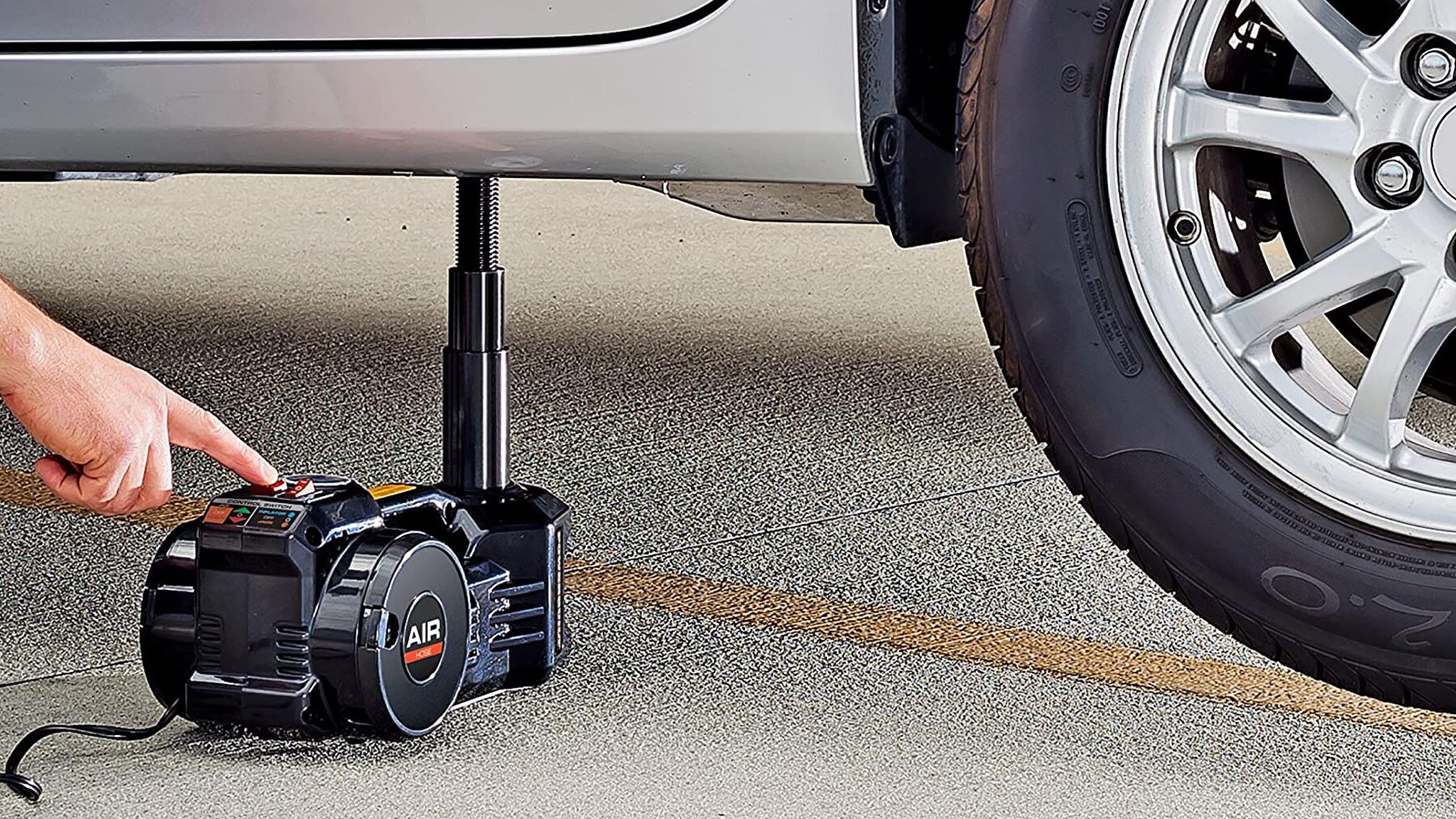 An electric air jack underneath a vehicle. 