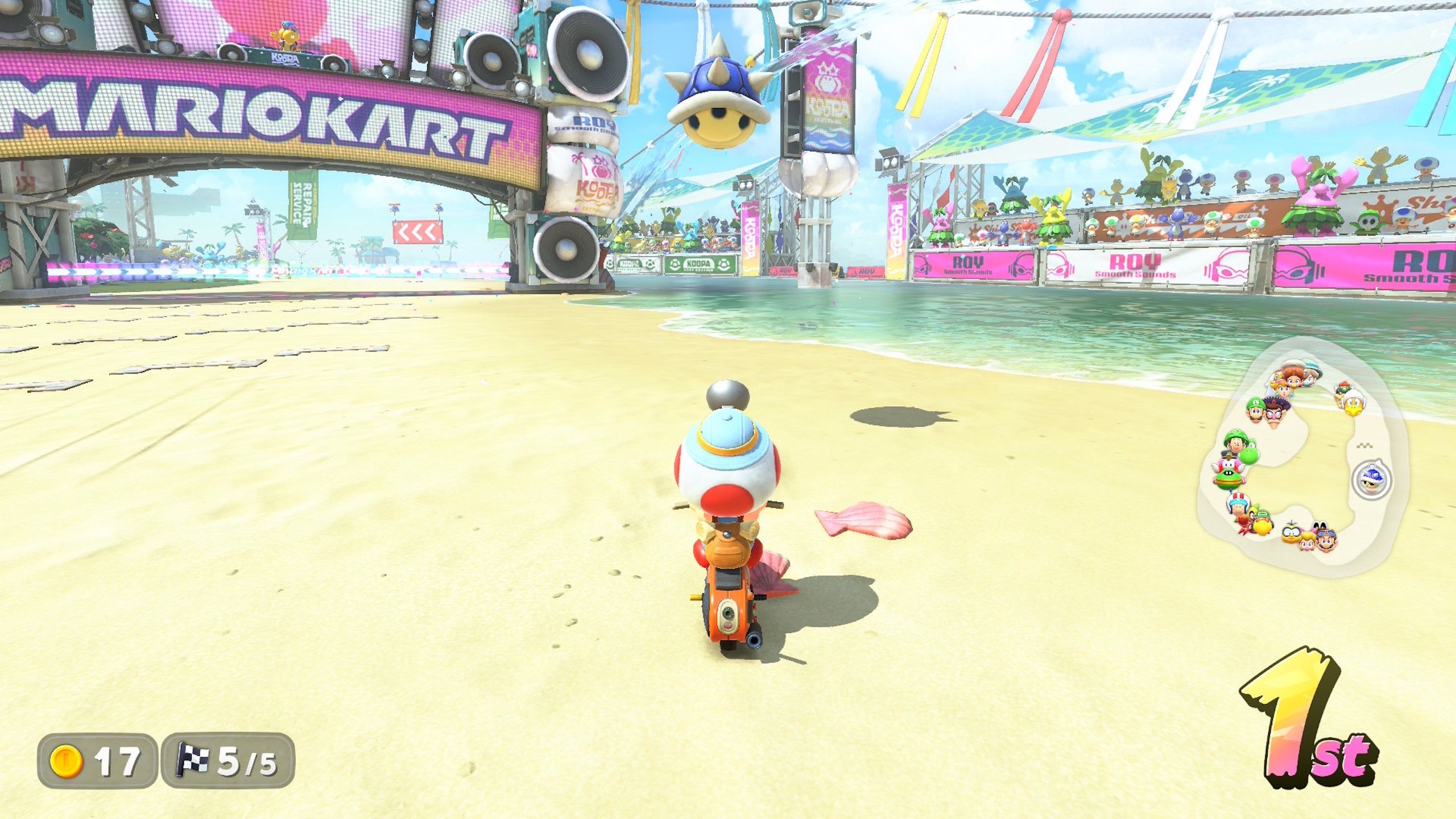 A blue shell about to hit a character just before the finish line on the final lap of a race in Mario Kart World.