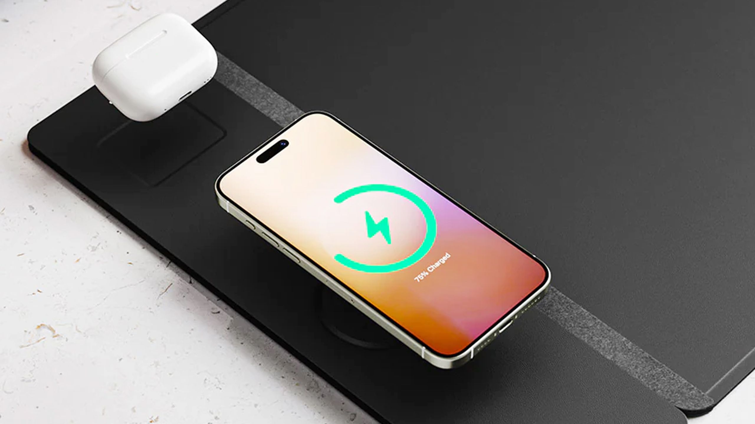 A Journey Alti desk mat with an iPhone and the AirPods Pro.