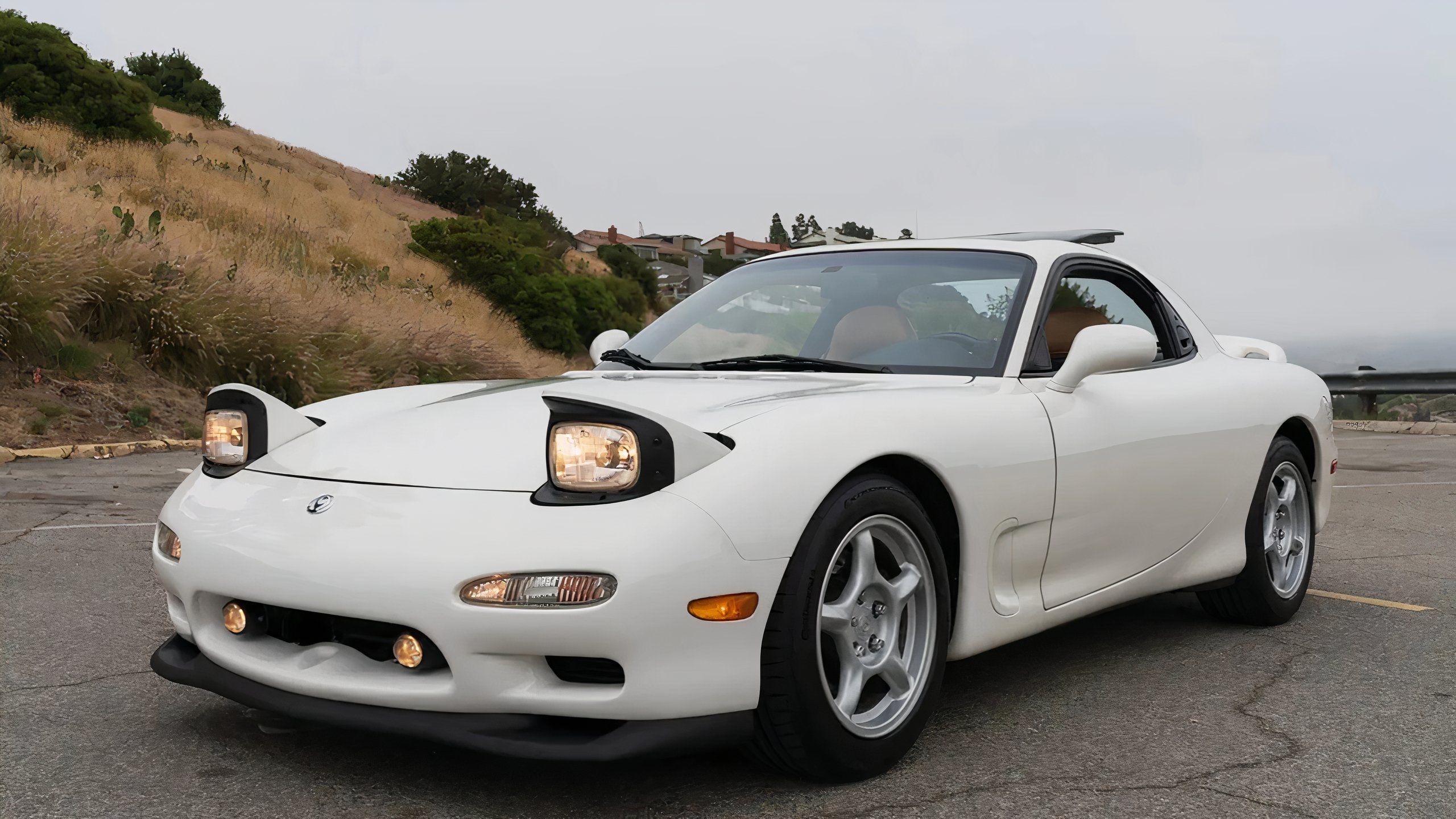 A 1994 Mazda RX-7 with its pop-up headlights engaged. 
