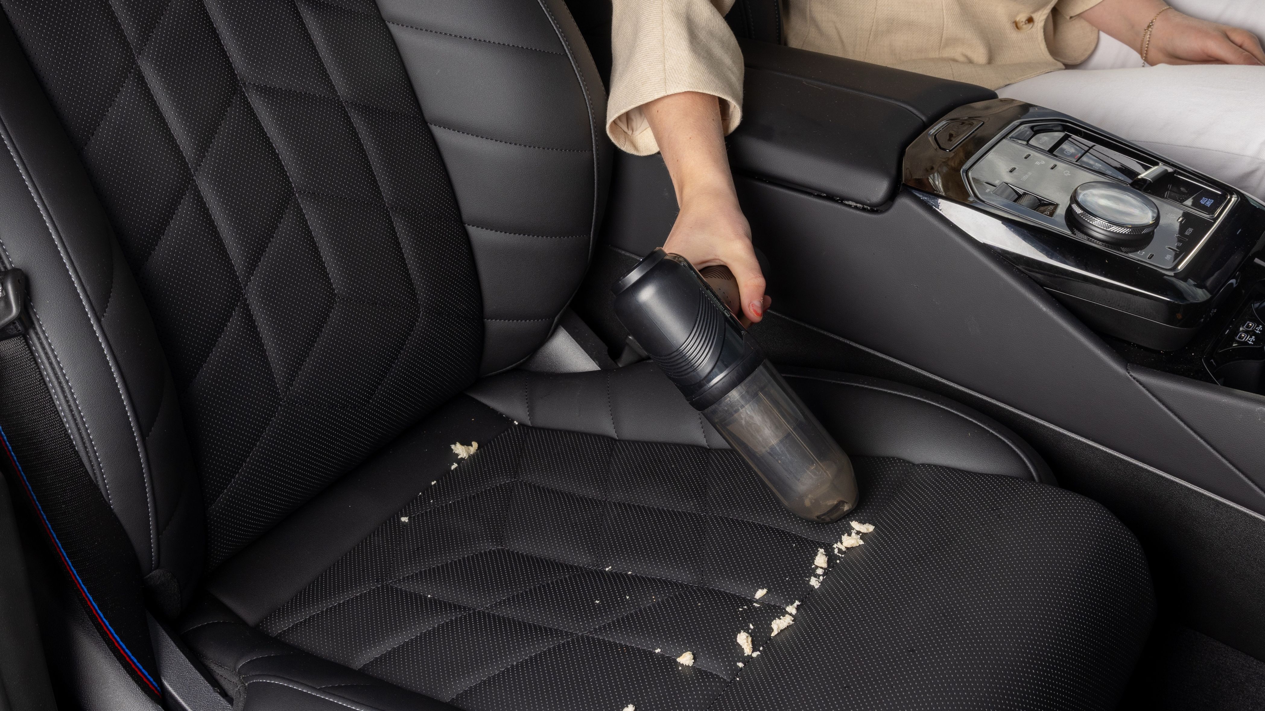 A hedgehog turbovac is used to vacuum debris on one seat. 