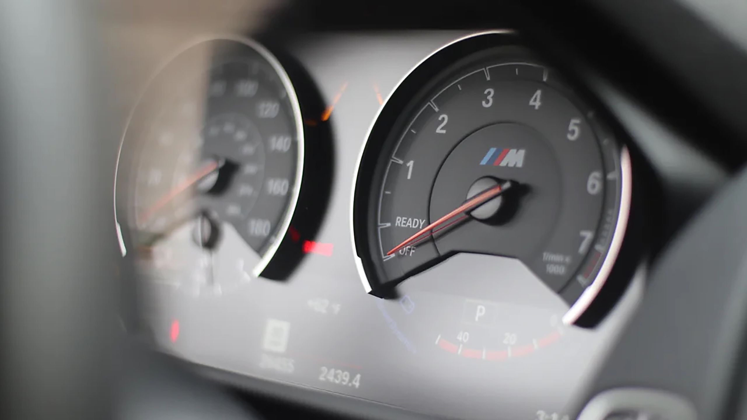 A BMW M2 gauge cluster in resting position. 