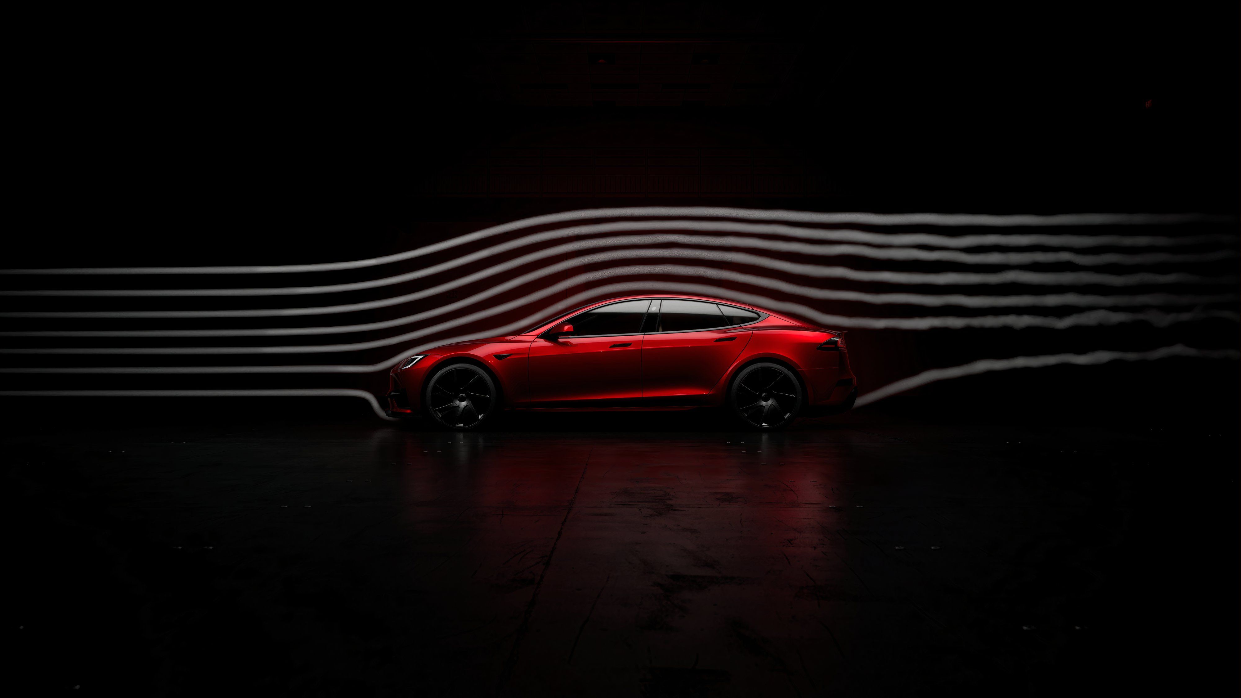 A still photo of a 2025 Tesla Model S showing its aerodynamic flow in a wind tunnel. 