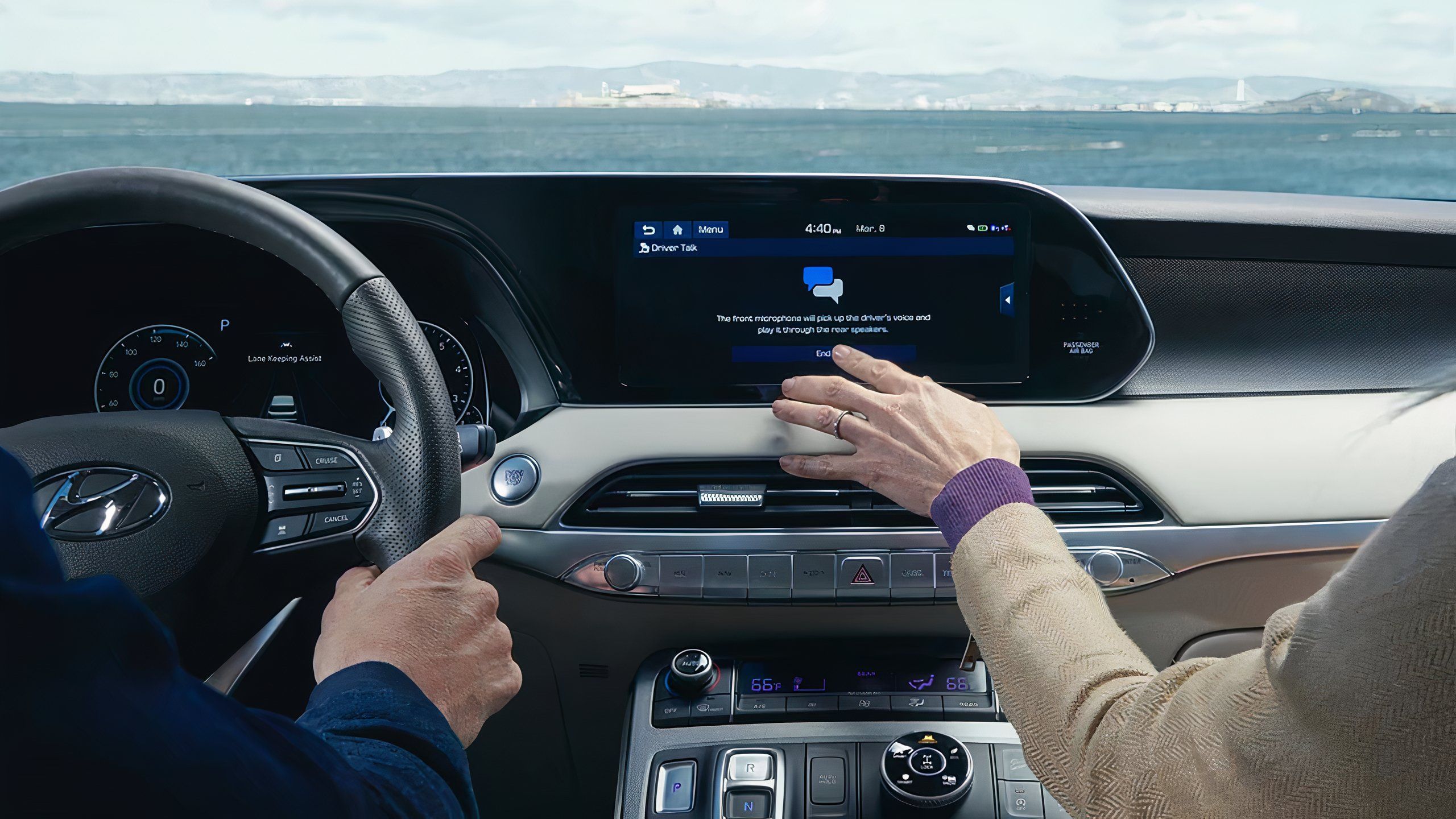 A still photo of a passenger using the Hyundai Blue Link infotainment system. 