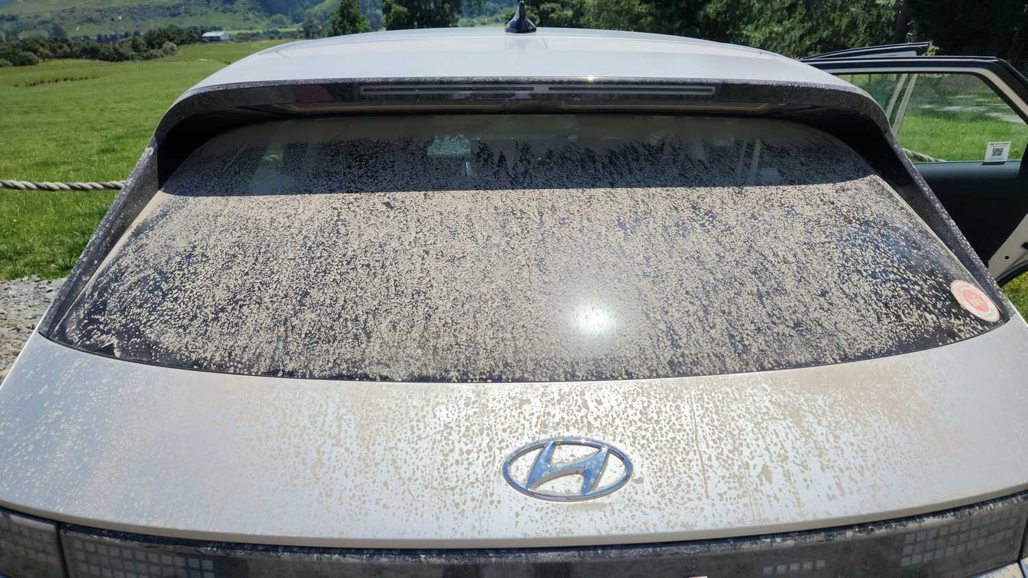 A still photo of a very dirt Hyundai Ioniq 5 rear window.