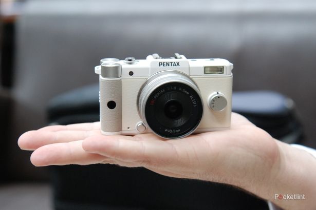 pentax q teeny tiny hybrid camera finger tips on image 1