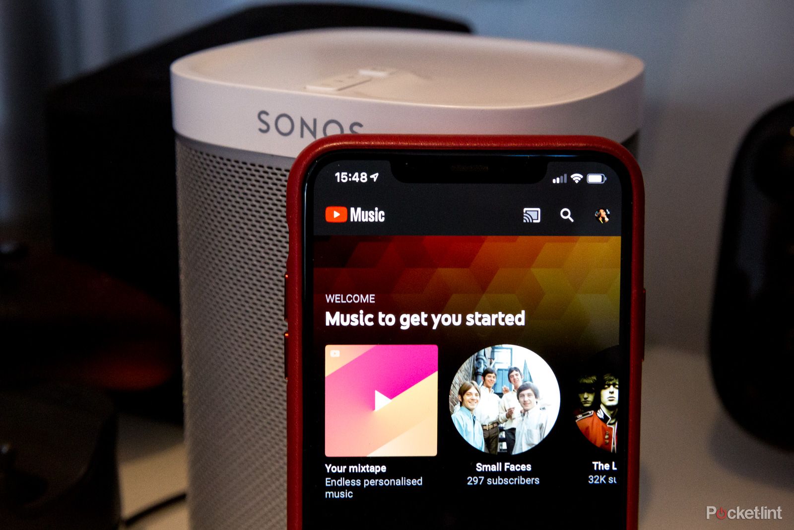YouTube Music on iPhone in front of a Sonos speaker