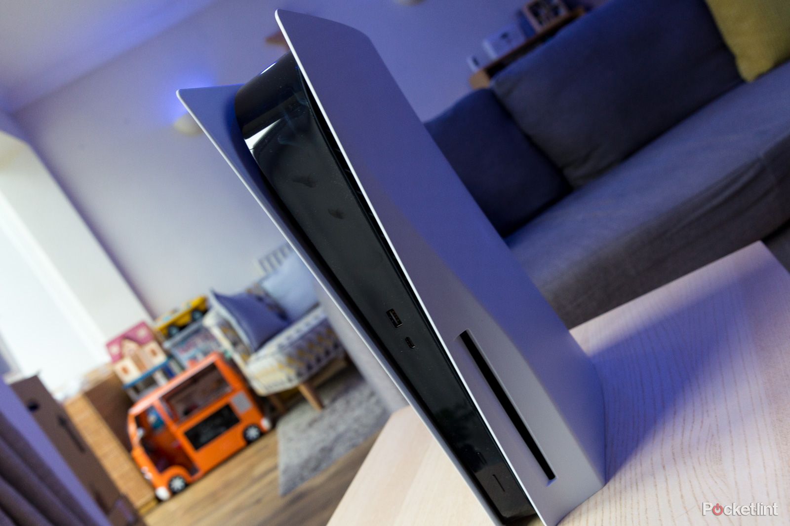 PlayStation five stood vertically on a coffee table