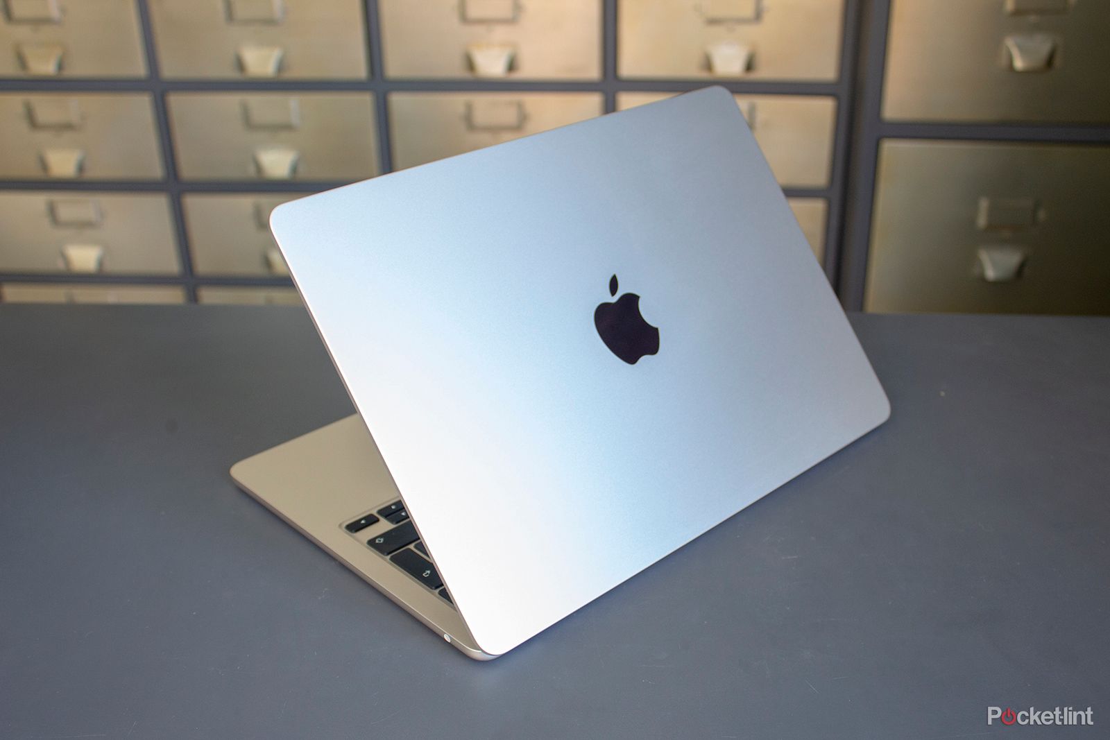 Apple MacBook Air on a desk with filing cabinets in the background