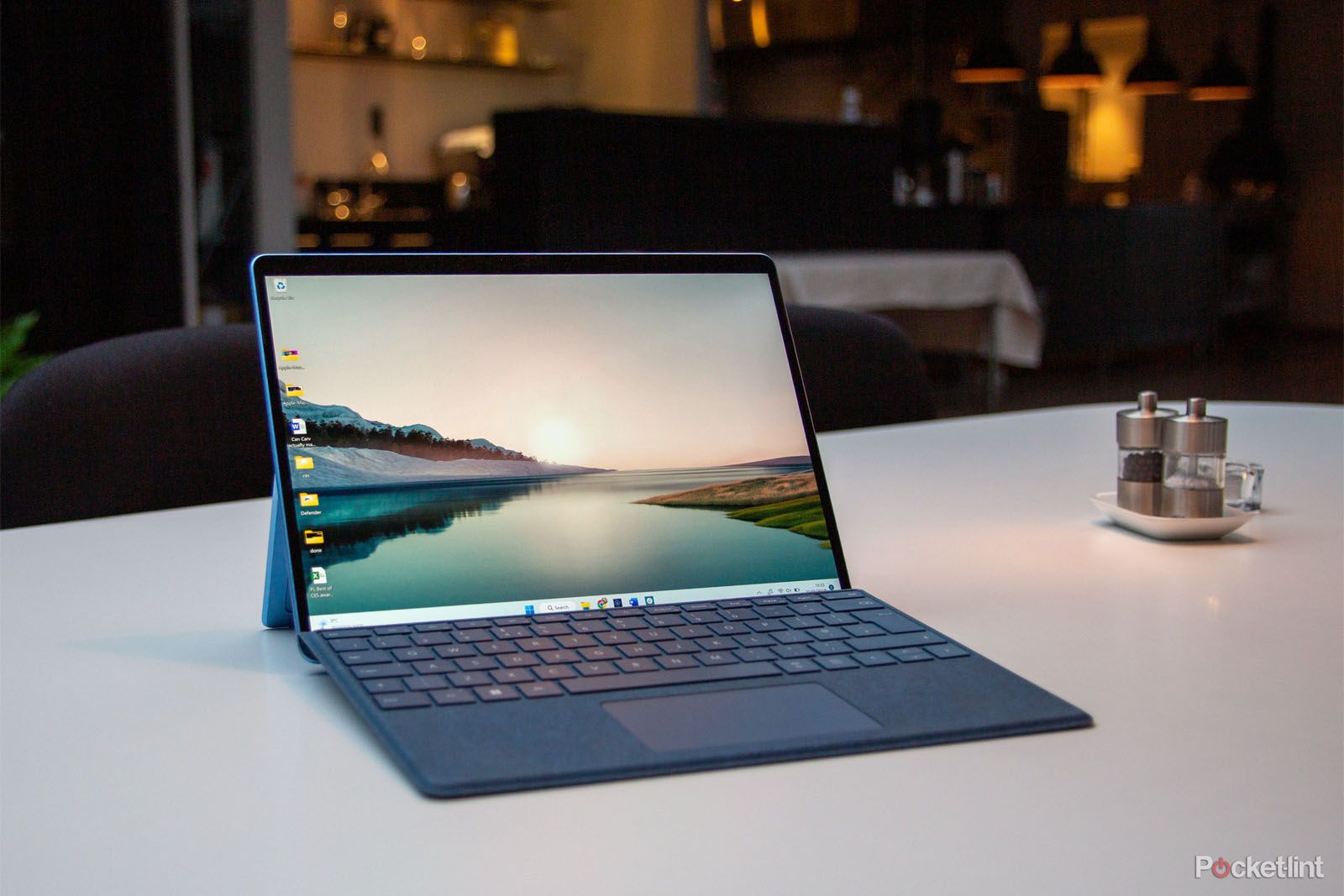Microsoft Surface Pro 9 in laptop mode with attached blue keyboard on a countertop. 