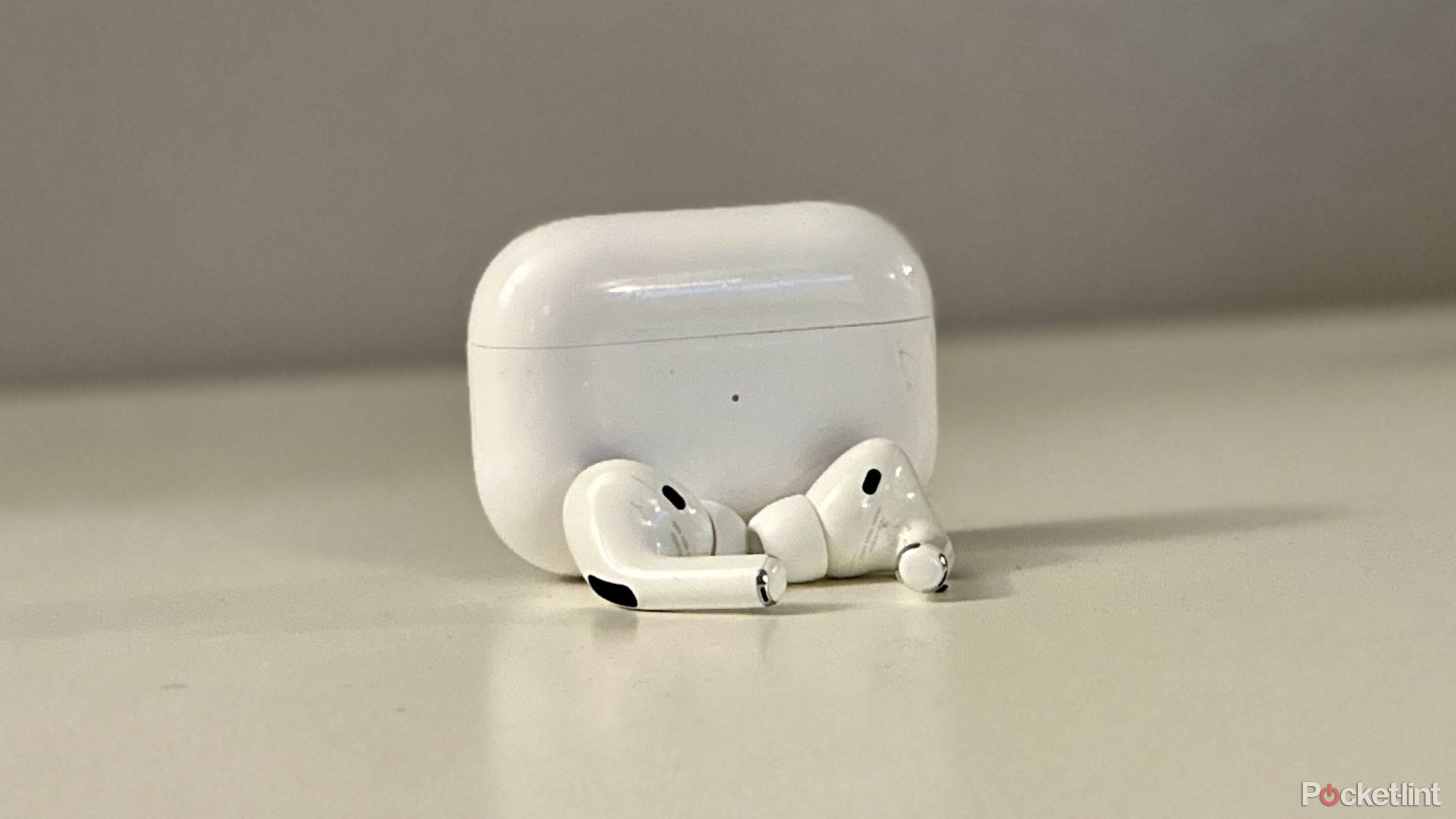 AirPods Pro on a table with their case