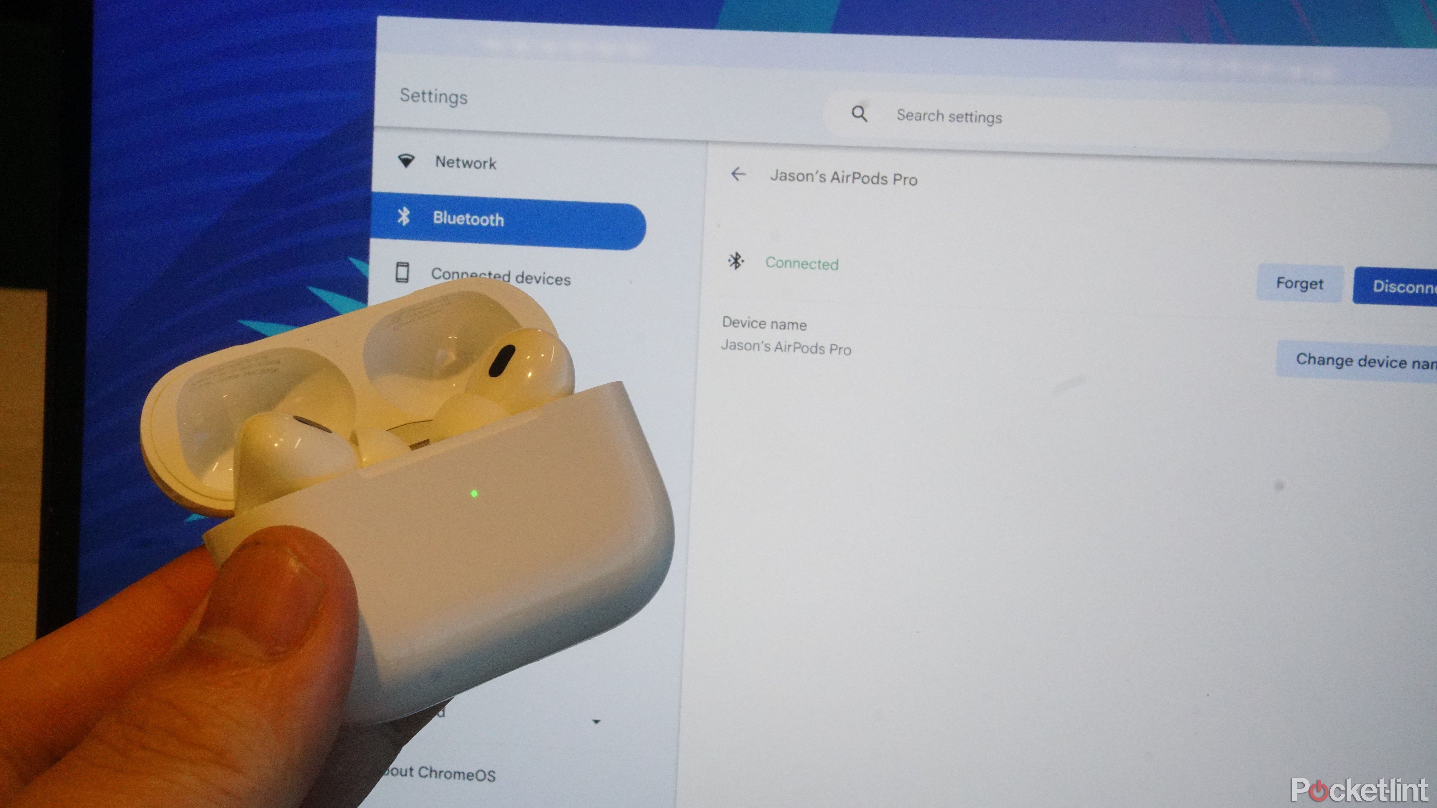 AirPods in front of a Chromebook with the Bluetooth settings page for the AirPods.