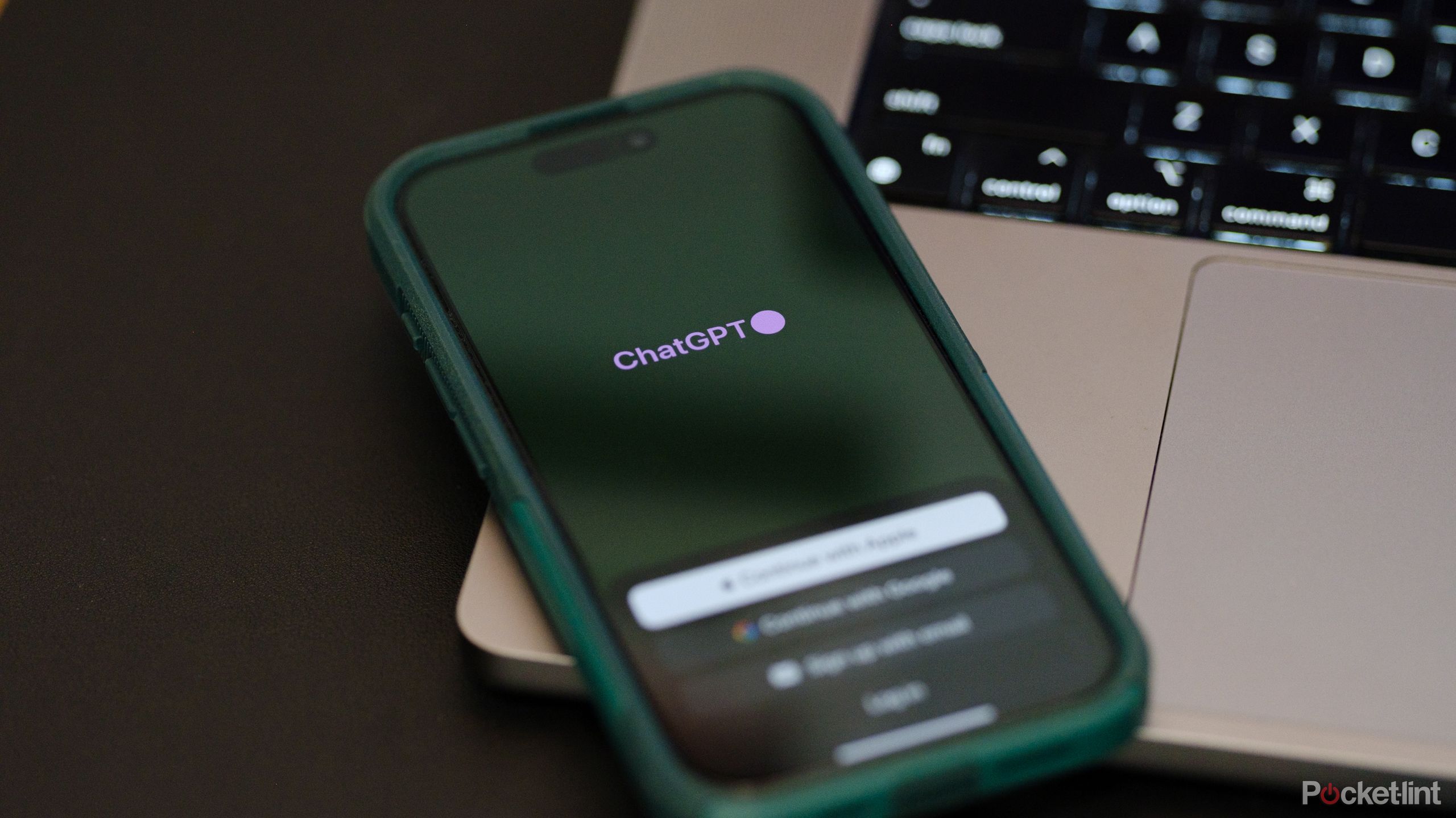The ChatGPT app on an iPhone next to a MacBook