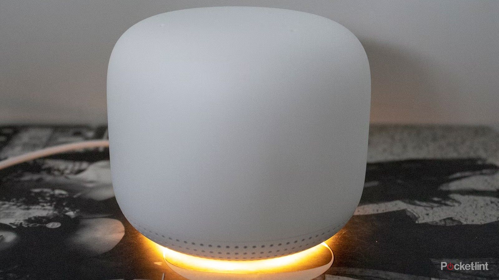 The Nest Mesh Wi-Fi sits on a table