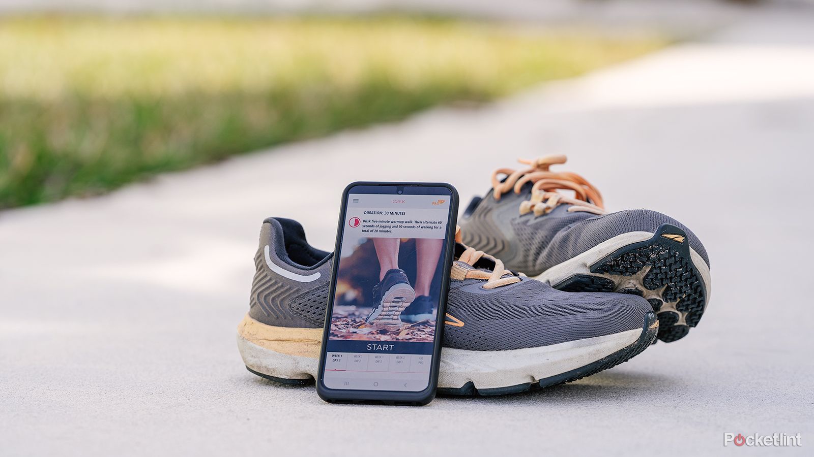 An Android phone on a pair of running shoes