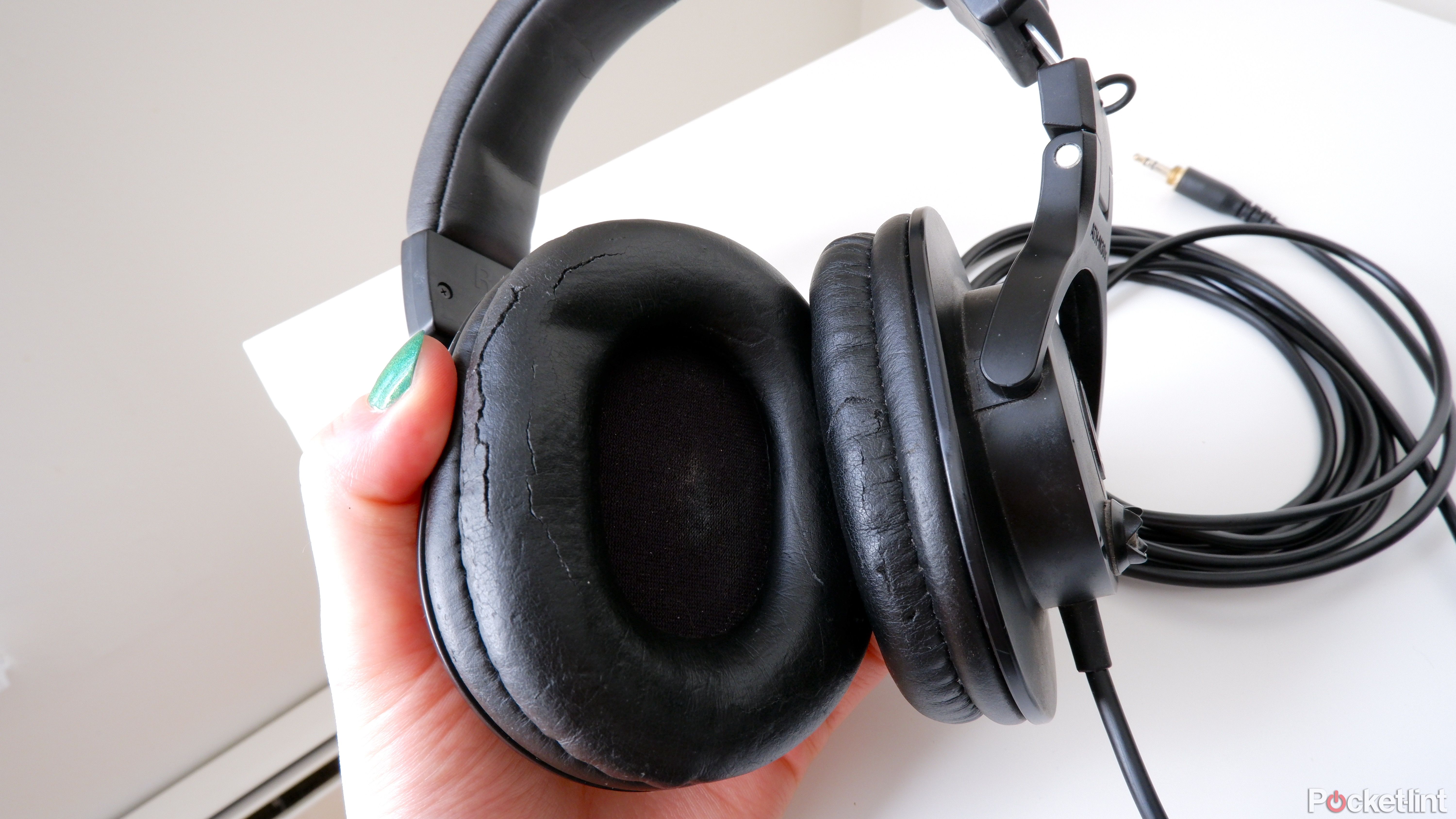 The Audio-Technica ATH-M30x being held by a hand, showing the ear cups close up