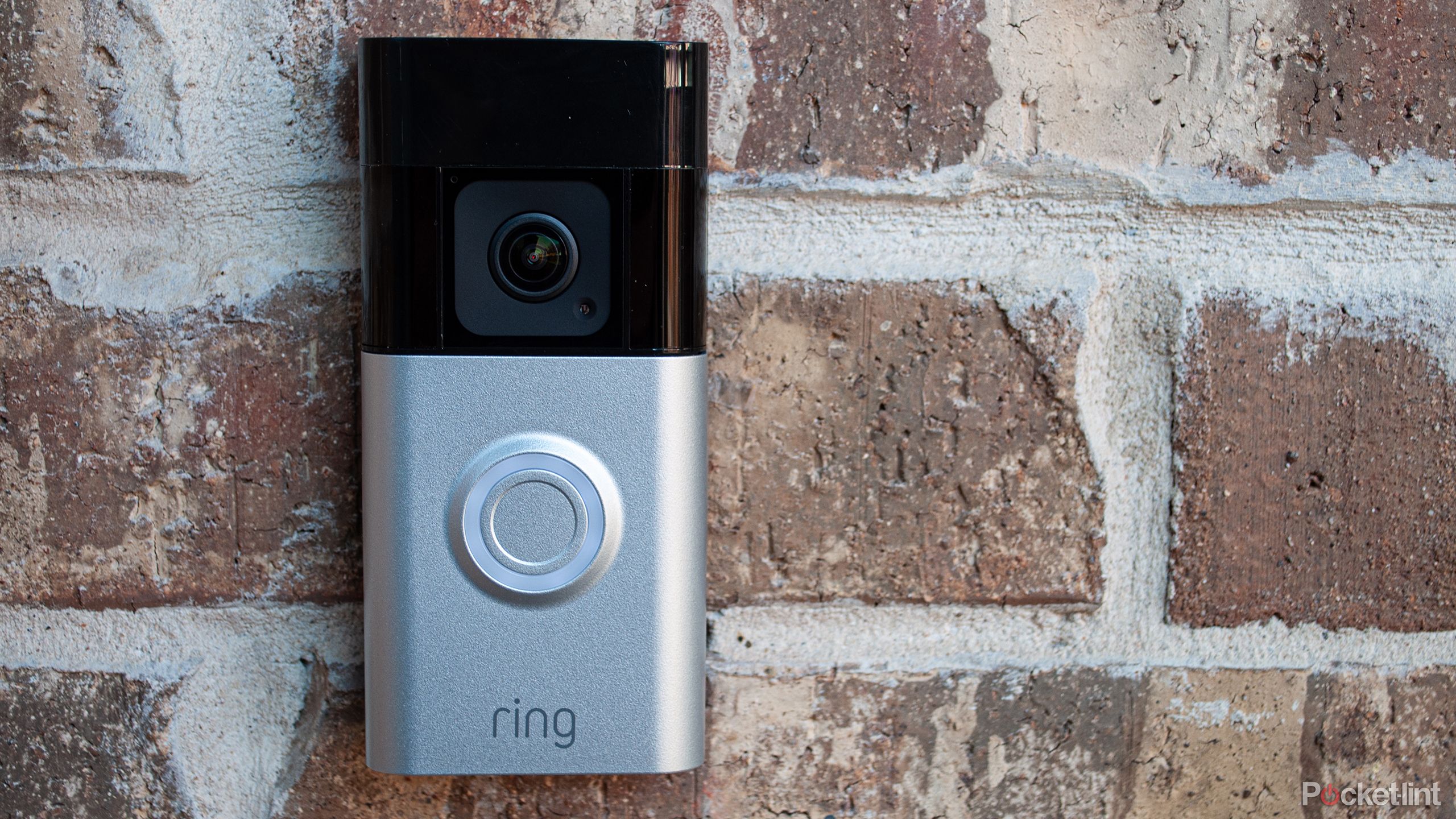 The Battery Doorbell Pro sits against a brick wall