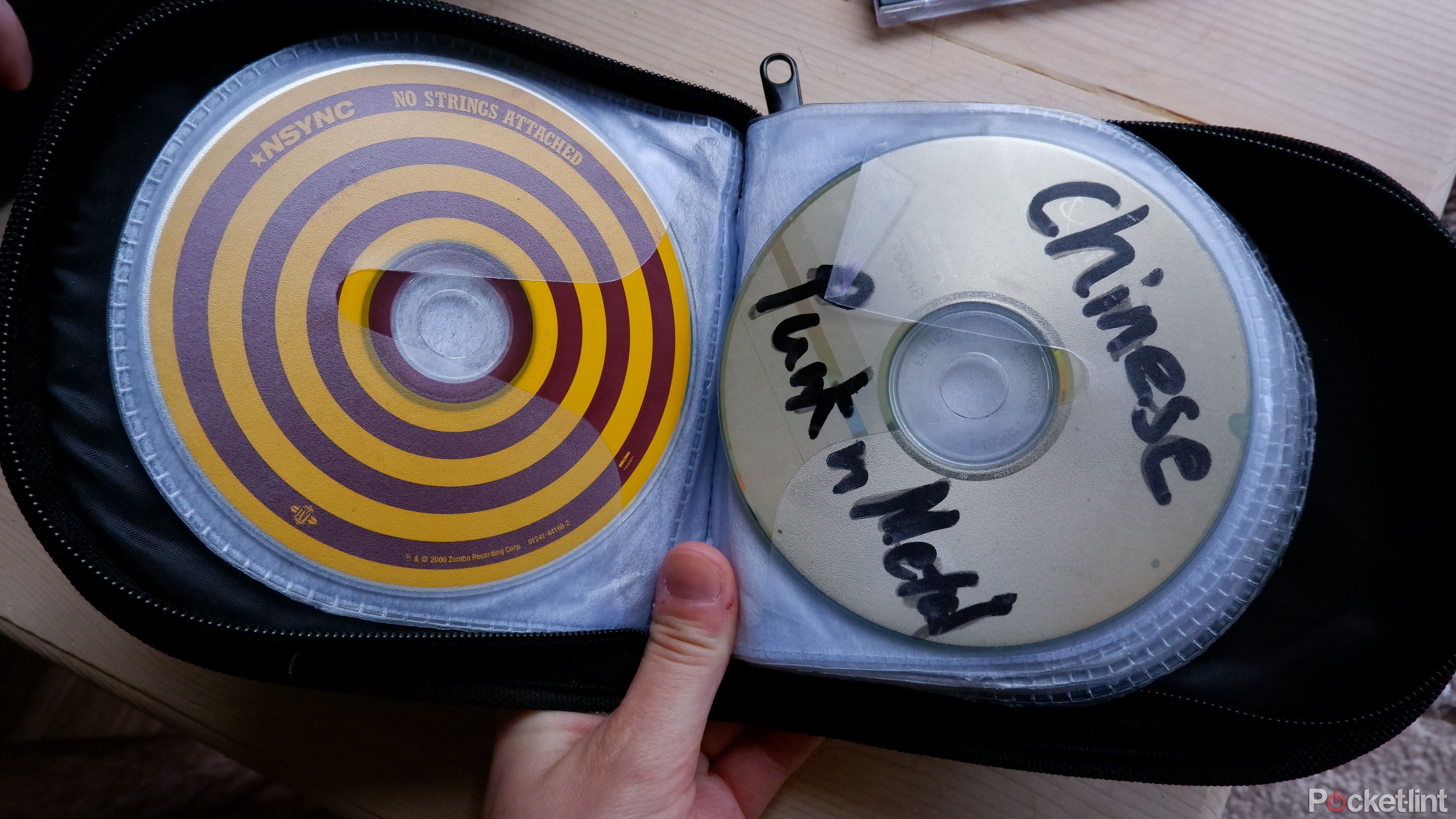 A travel CD case with an NSYNC CD in it