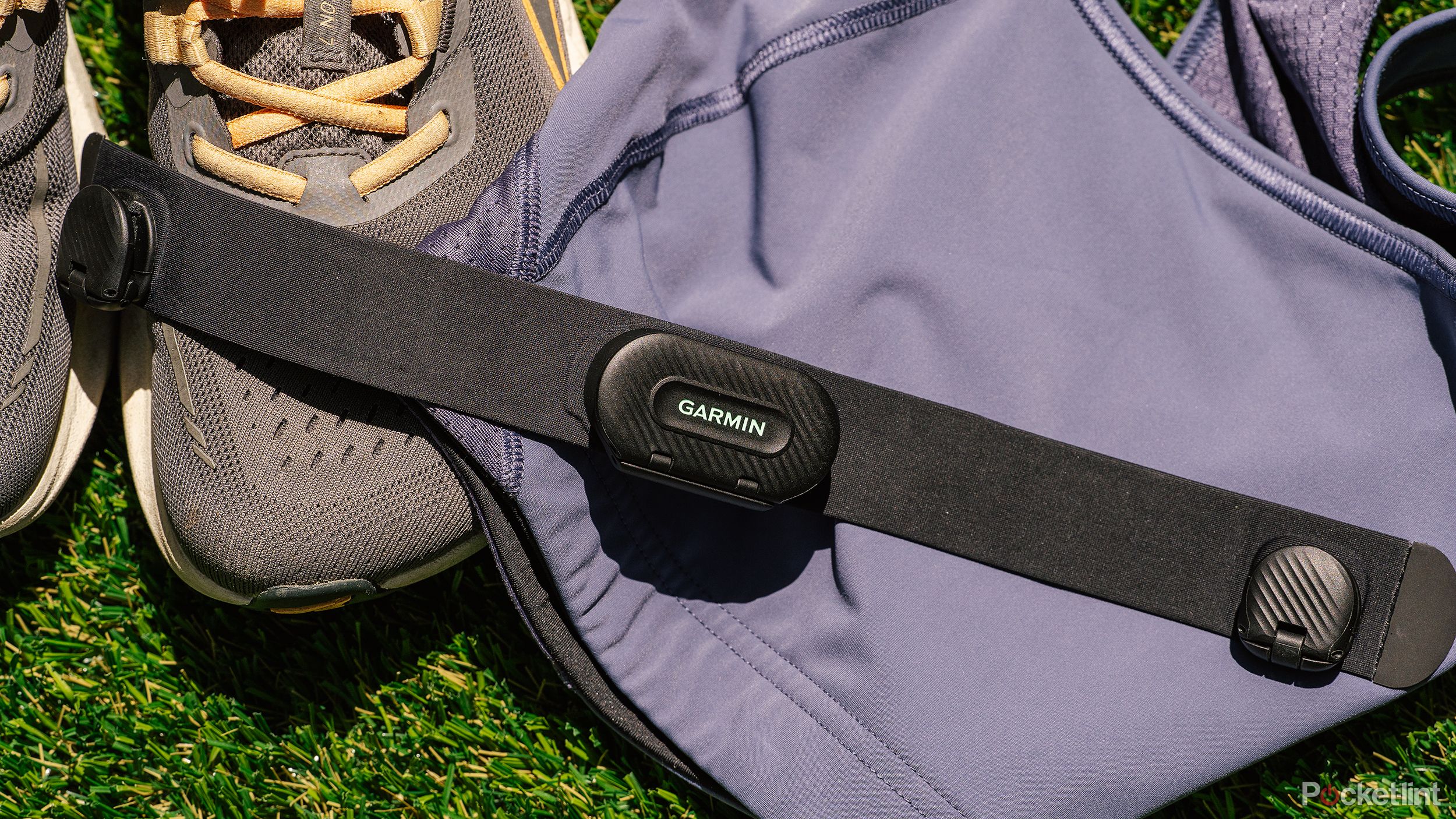 The Garmin HRM-Fit on a sports bra and pair of running shoes. 