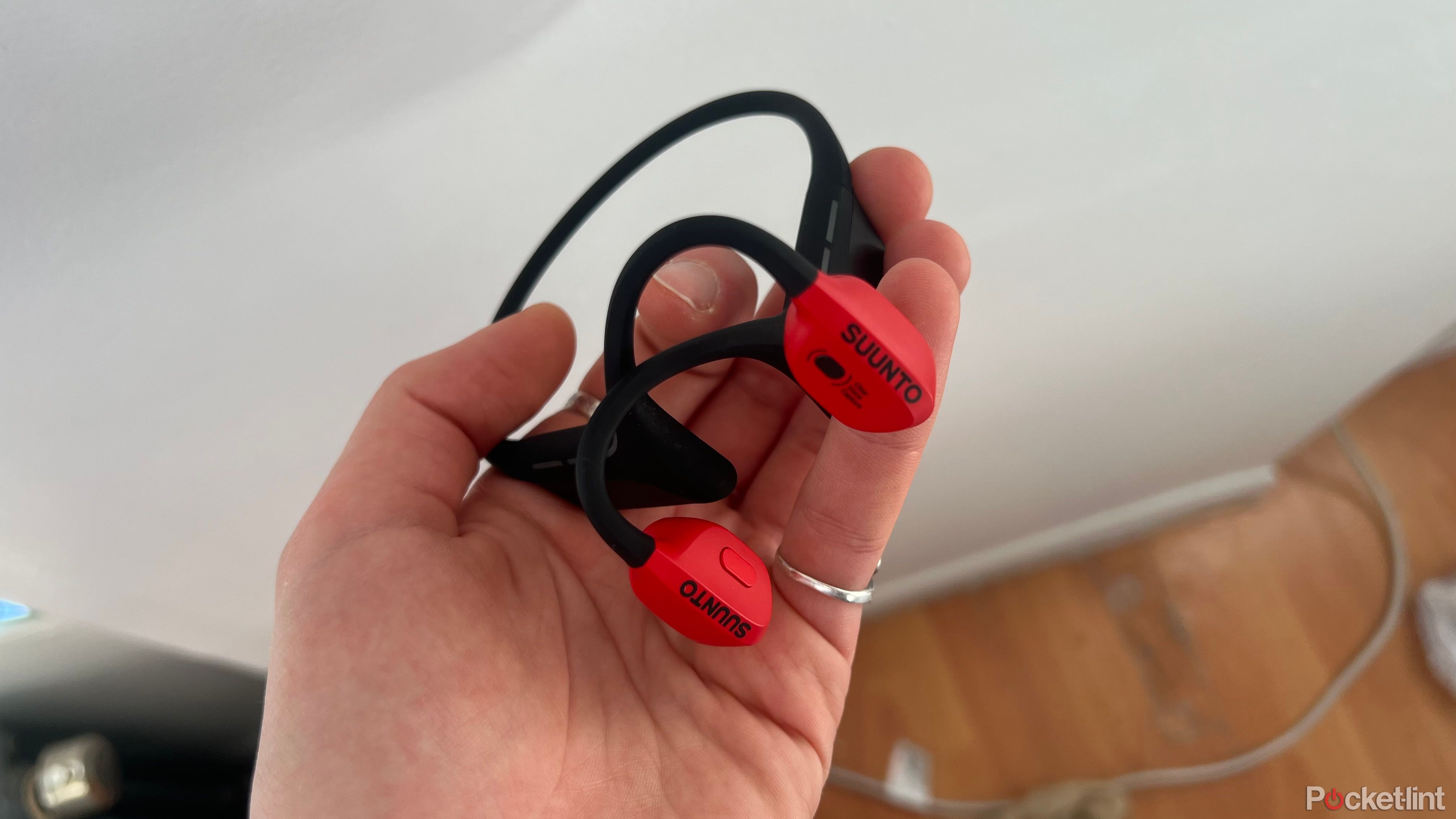 Suunto Wing headphones in hand