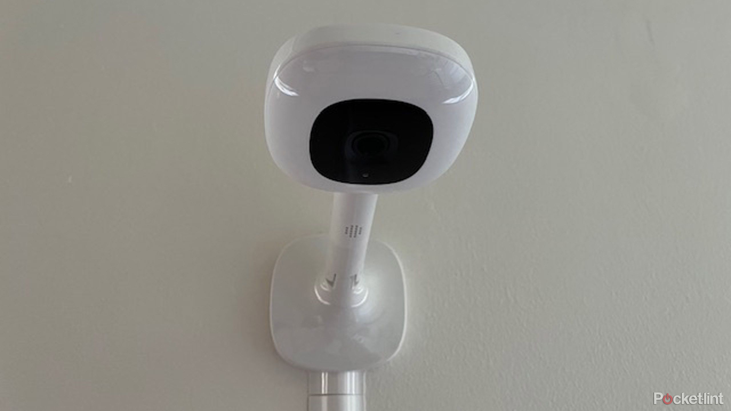 Nanit Pro baby monitor on white wall