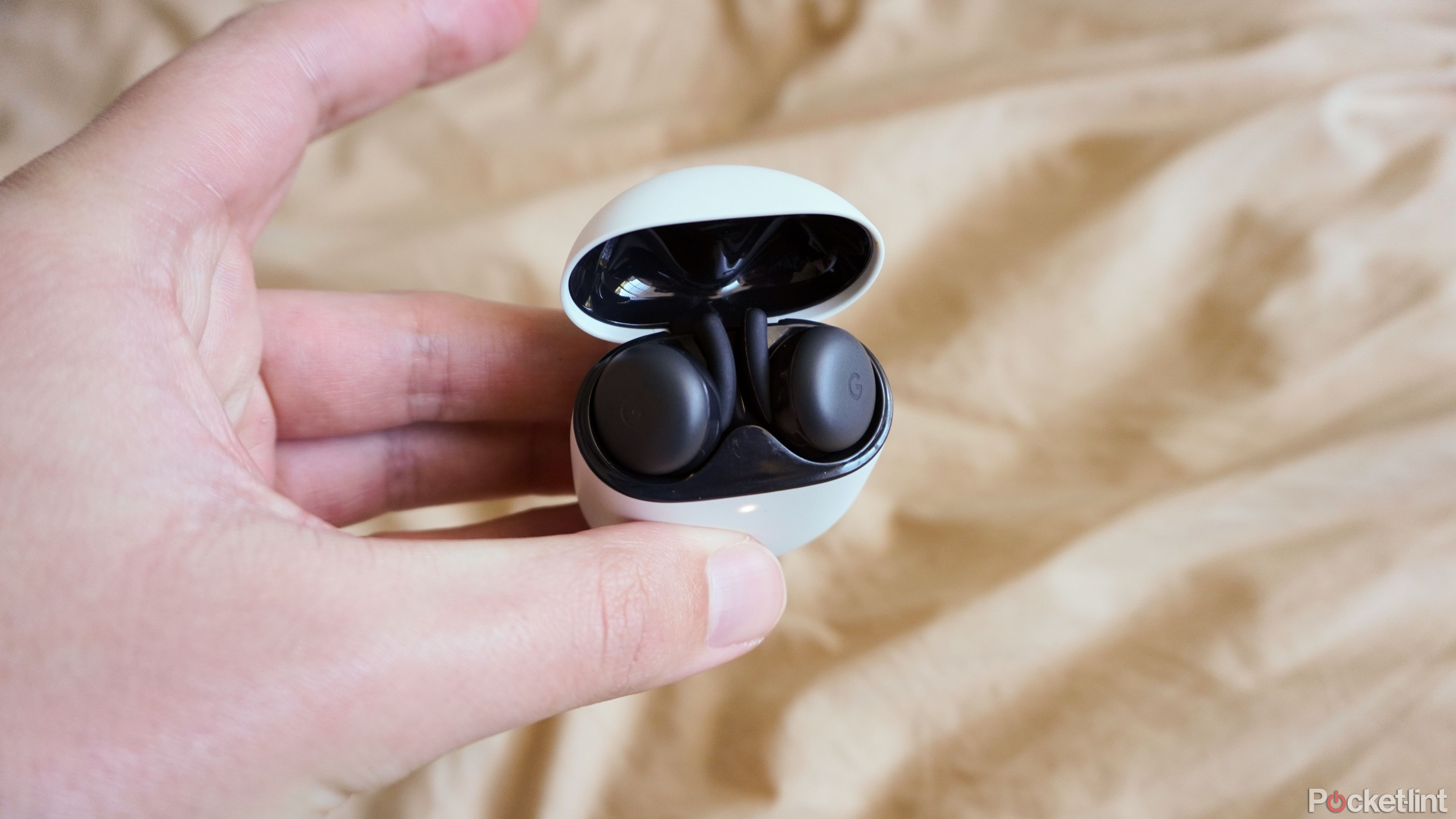 Pixel Buds earbuds sitting in a charging case.