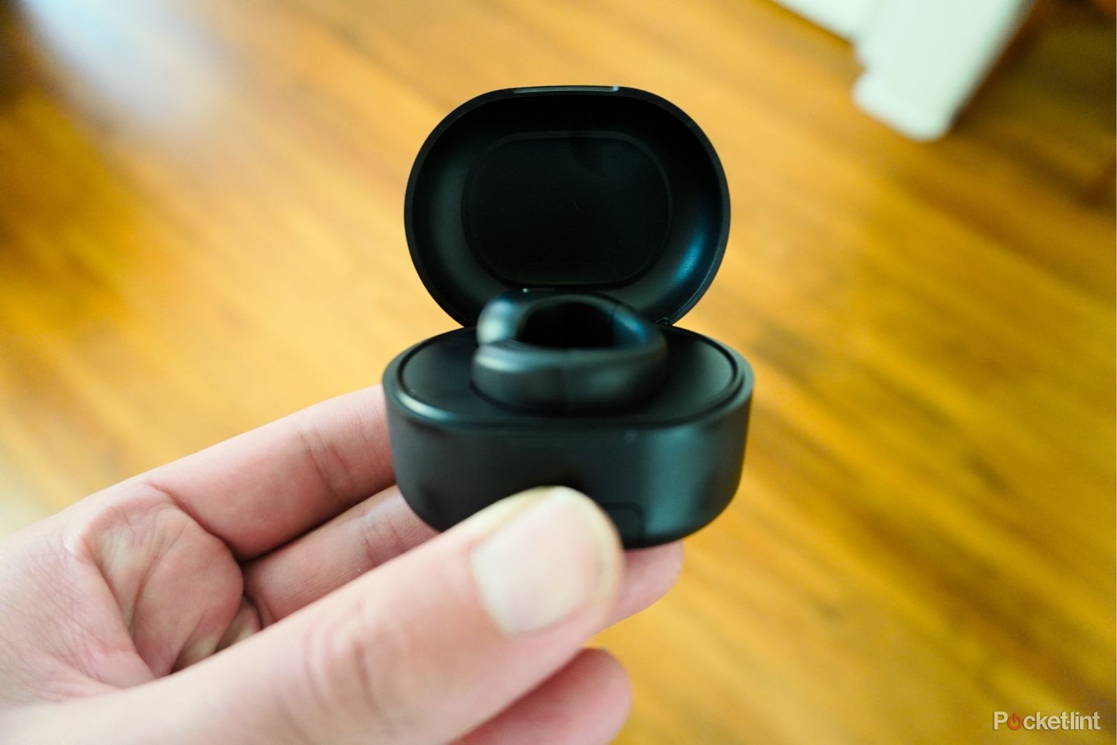 A charging case with a ring sitting in the center.