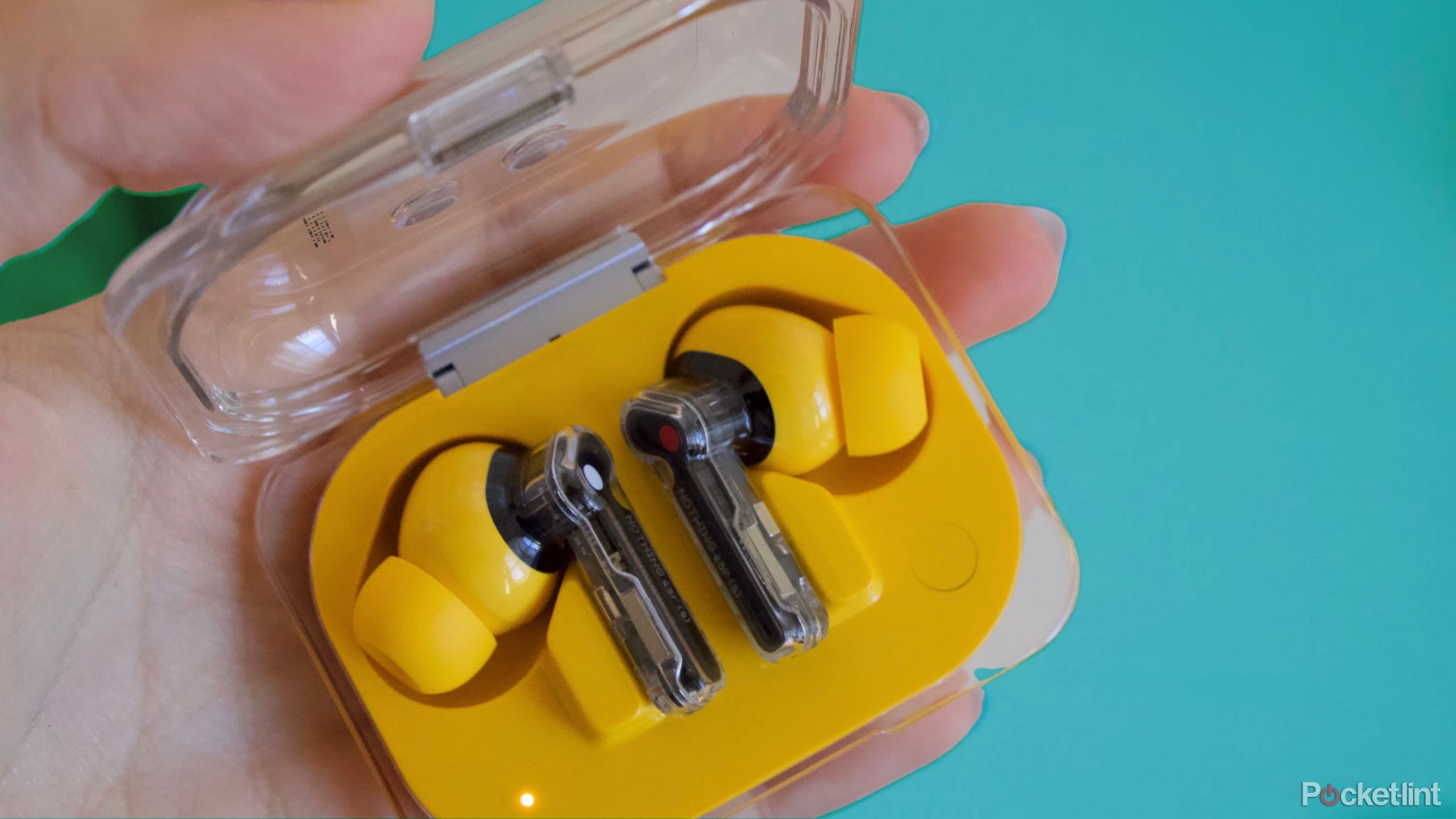 Nothing Ear (a) in hand yellow earbuds