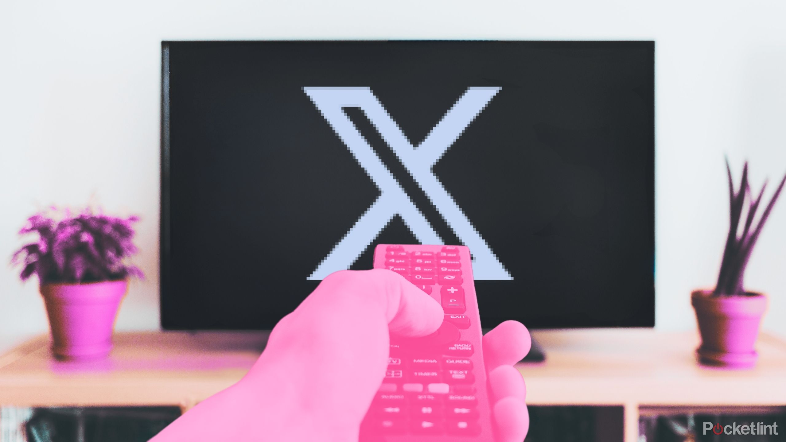 Pink remote pointing at X/Twitter logo on TV