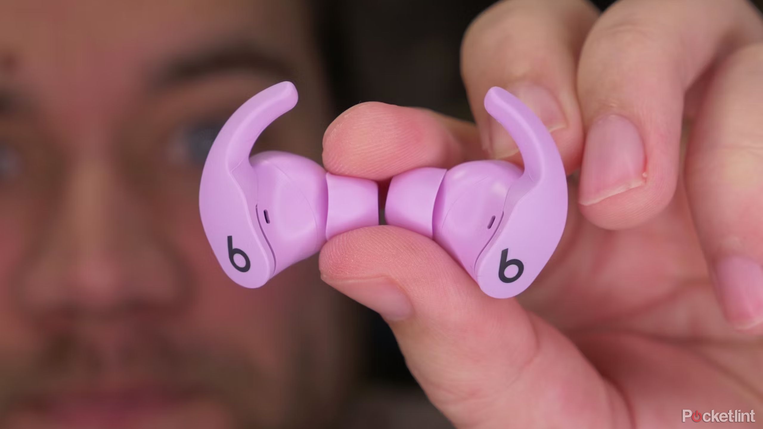 Pink Beats Fit Pro buds in hand.