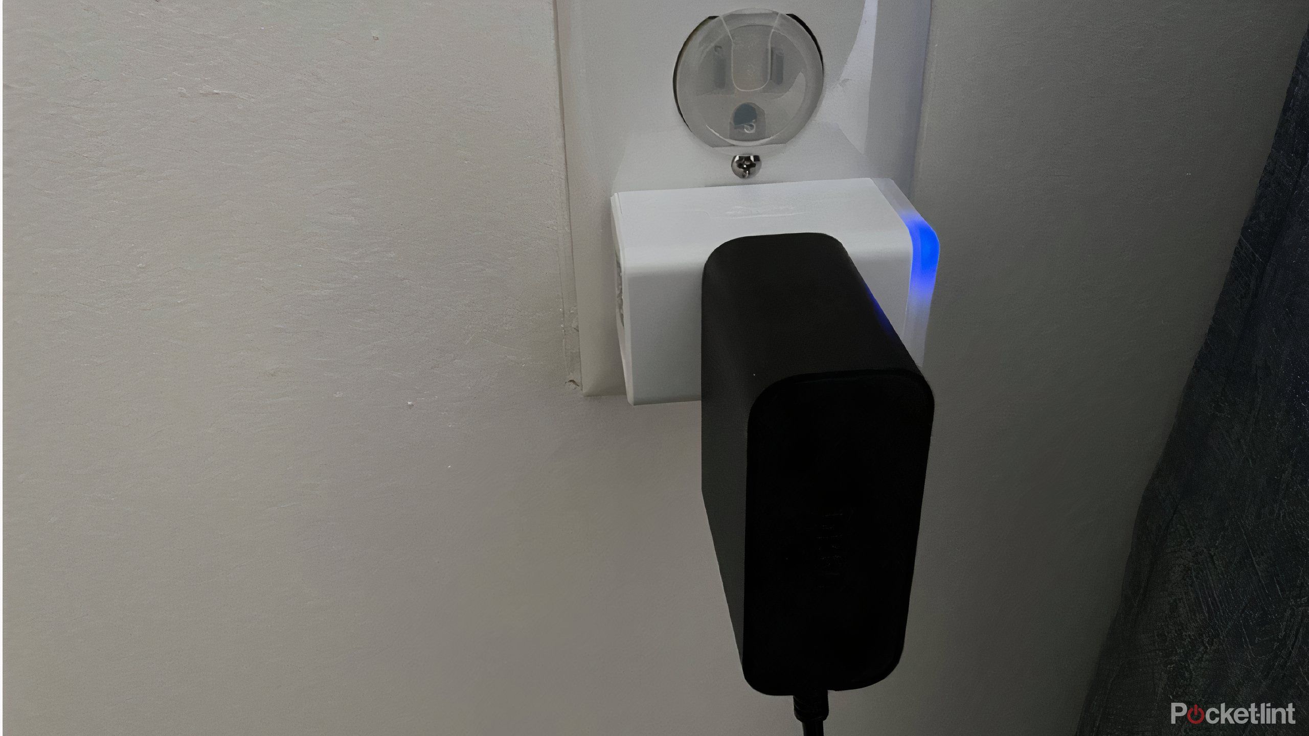 A Kasa smart plug with an air purifier plugged in.
