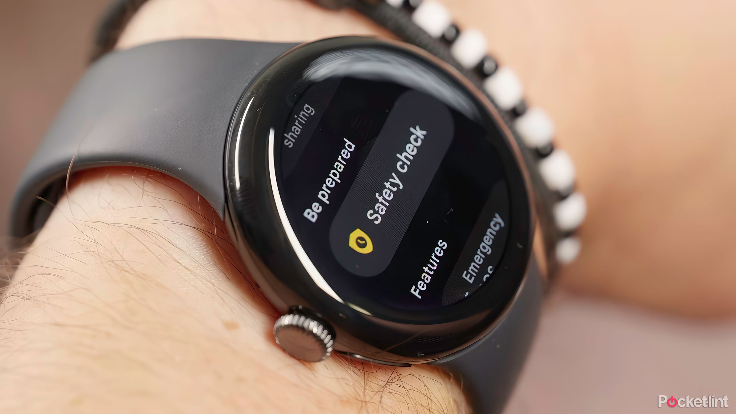 Google Pixel watch on a wrist displaying the Safety Check feature. 