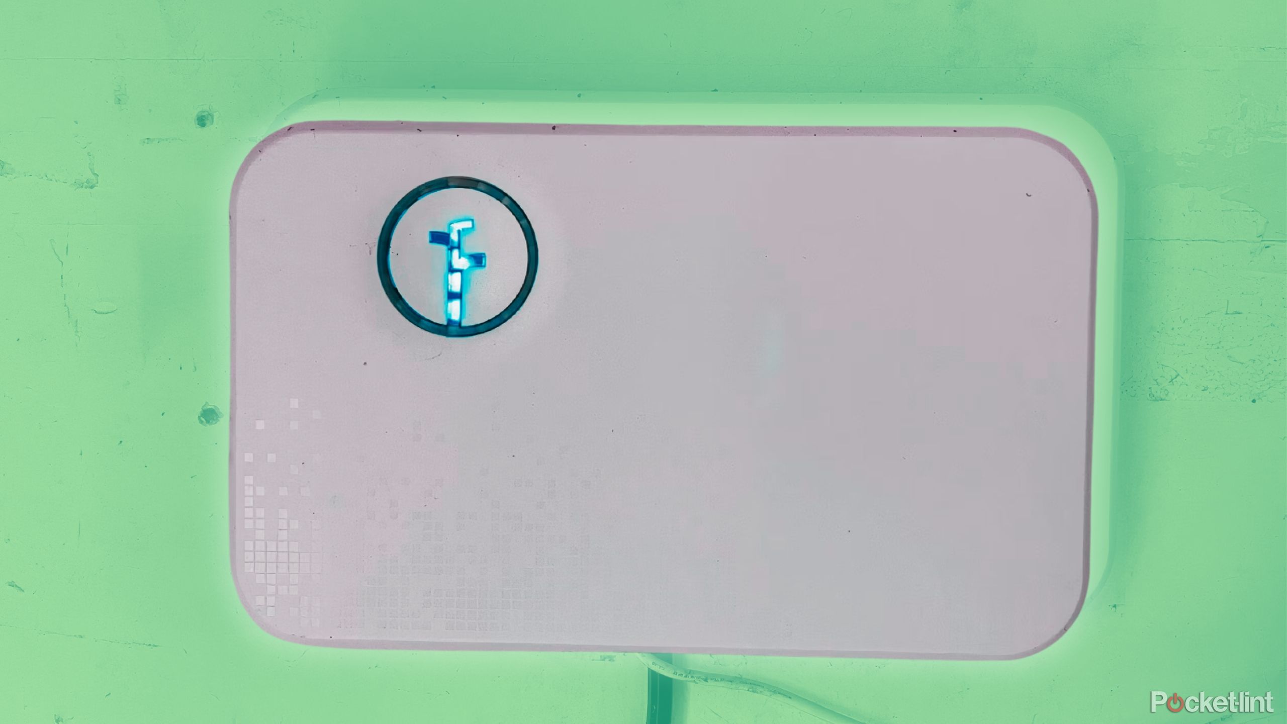 The Rachio Smart Sprinkler Controller Generation 2 on a green wall