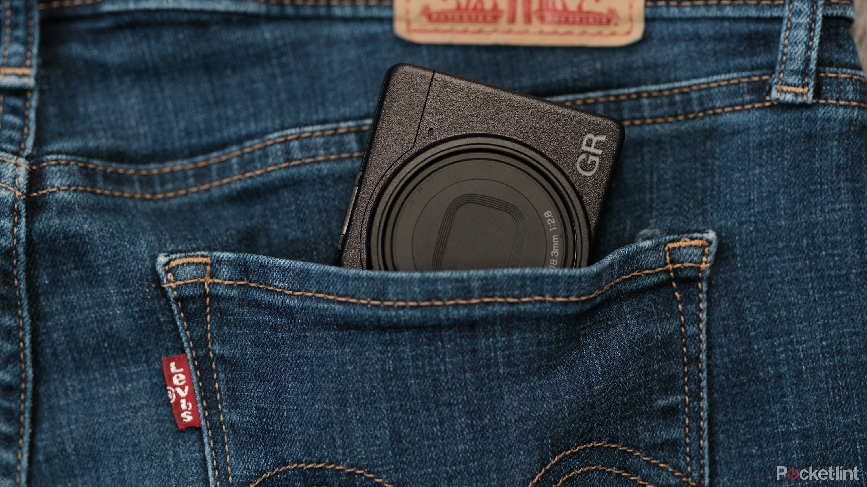 The Ricoh GR III HDF is shown tucked into a jeans pocket