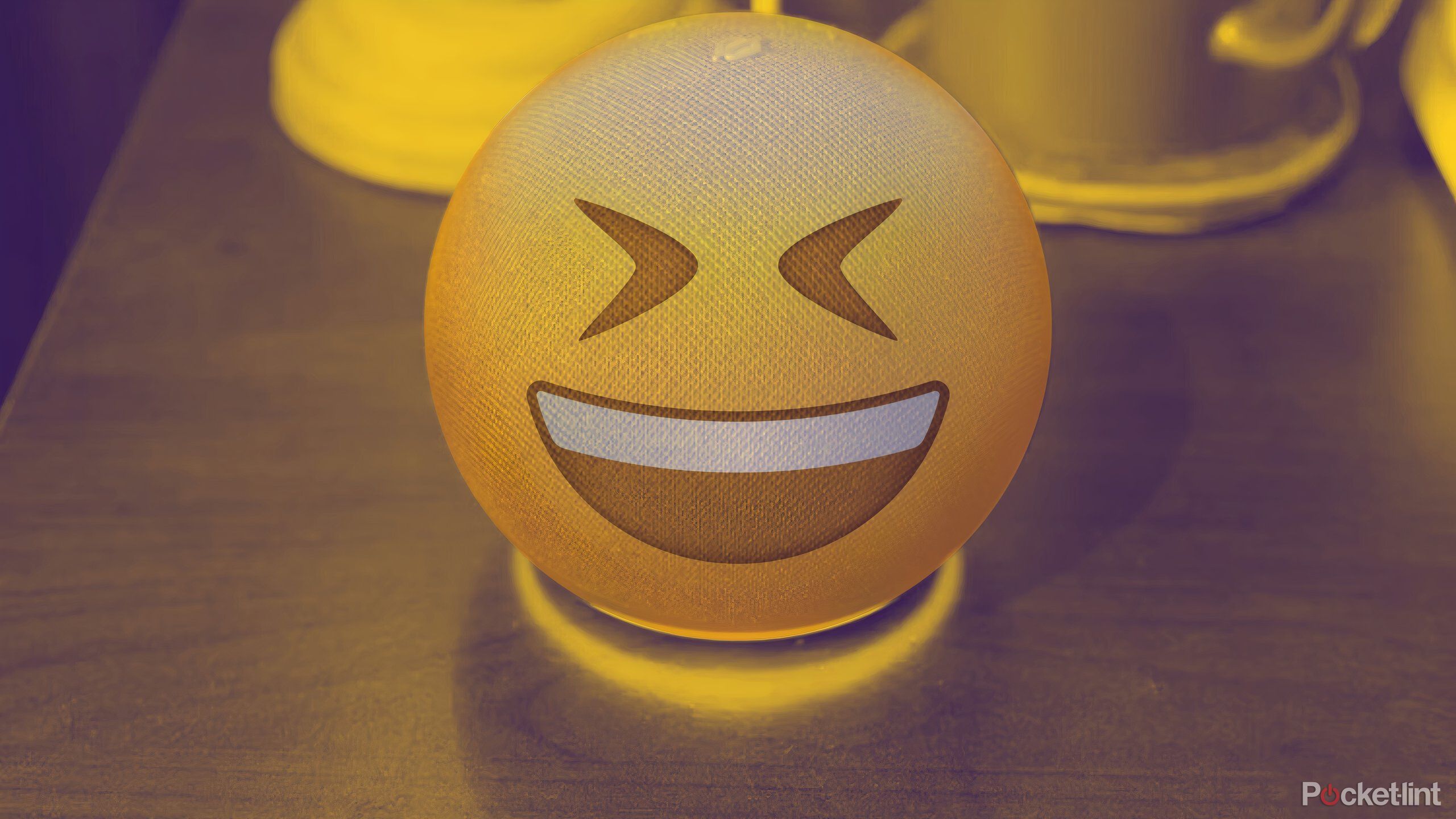 Amazon Echo with a laughing emoji superimposed over it