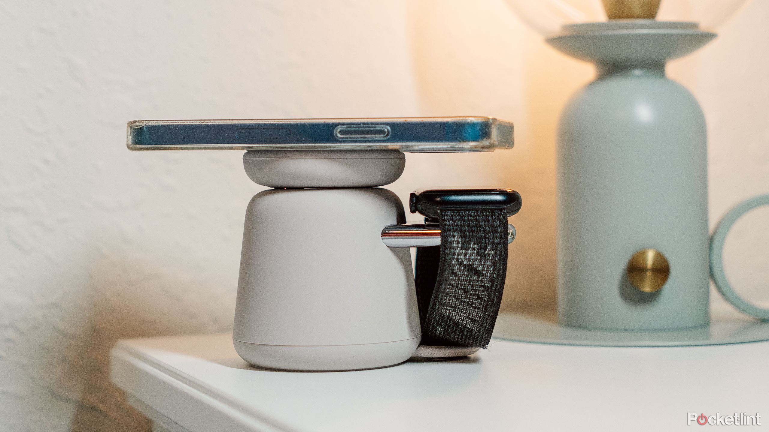 A nightstand with the Belkin Boost Charge Pro charging dock with an iPhone and Apple Watch on it. 