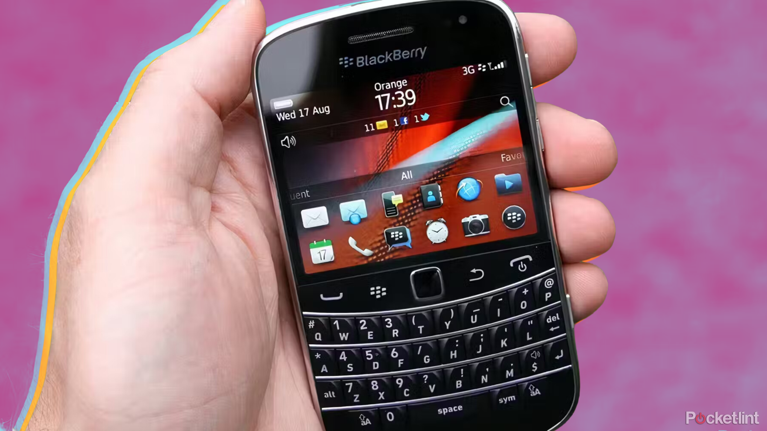 Blackberry in hand with pink background