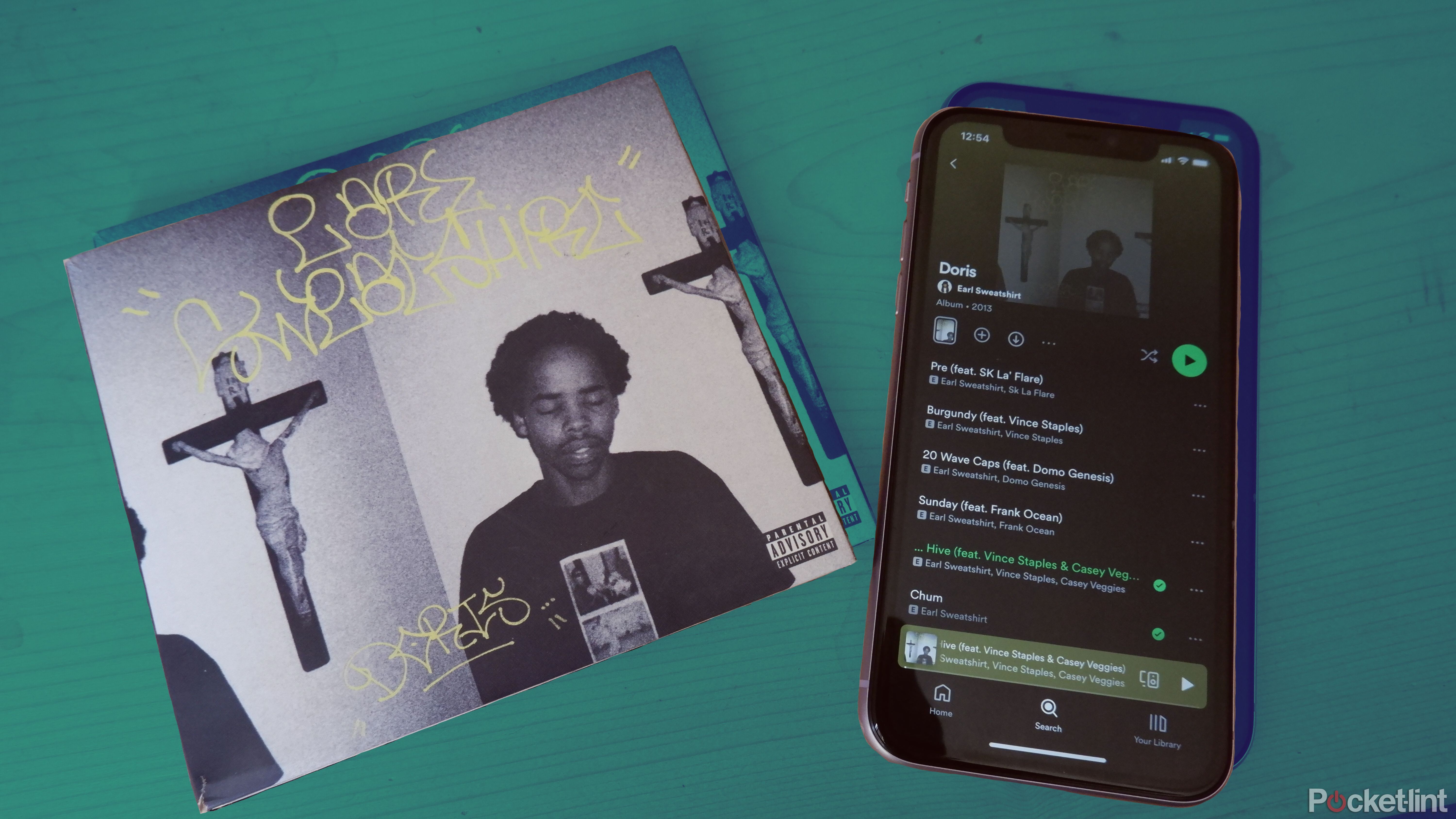 An Earl Sweatshirt album next to an iPhone with the same album open on Spotify.