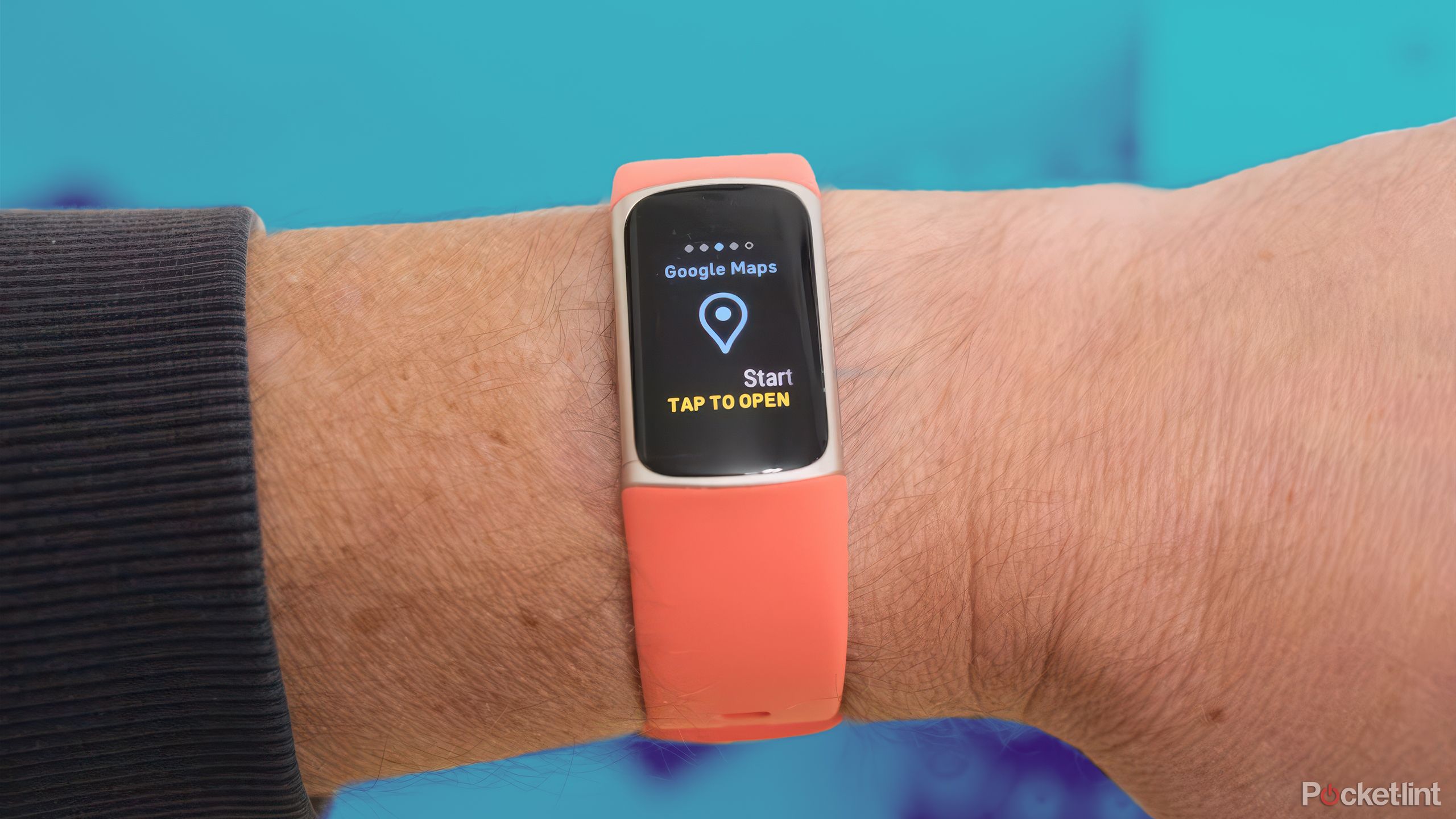 The FItbit Charge 6 against a blue, blurred background. 