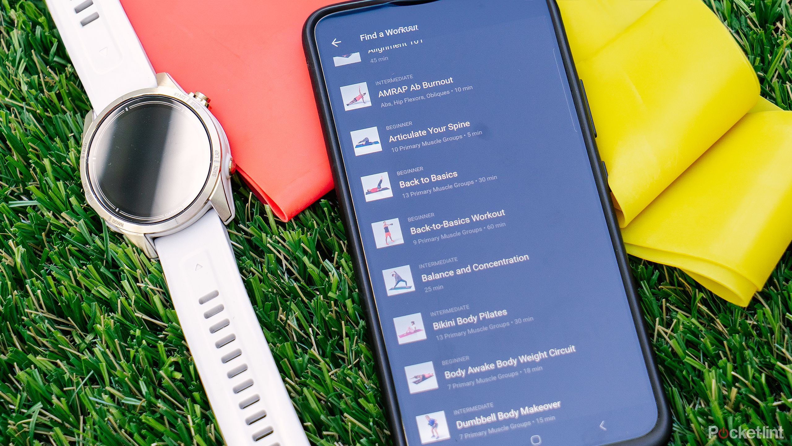 My phone with my Garmin workouts displayed next to my Garmin epix Pro Gen 2 and yellow and red exercise bands.