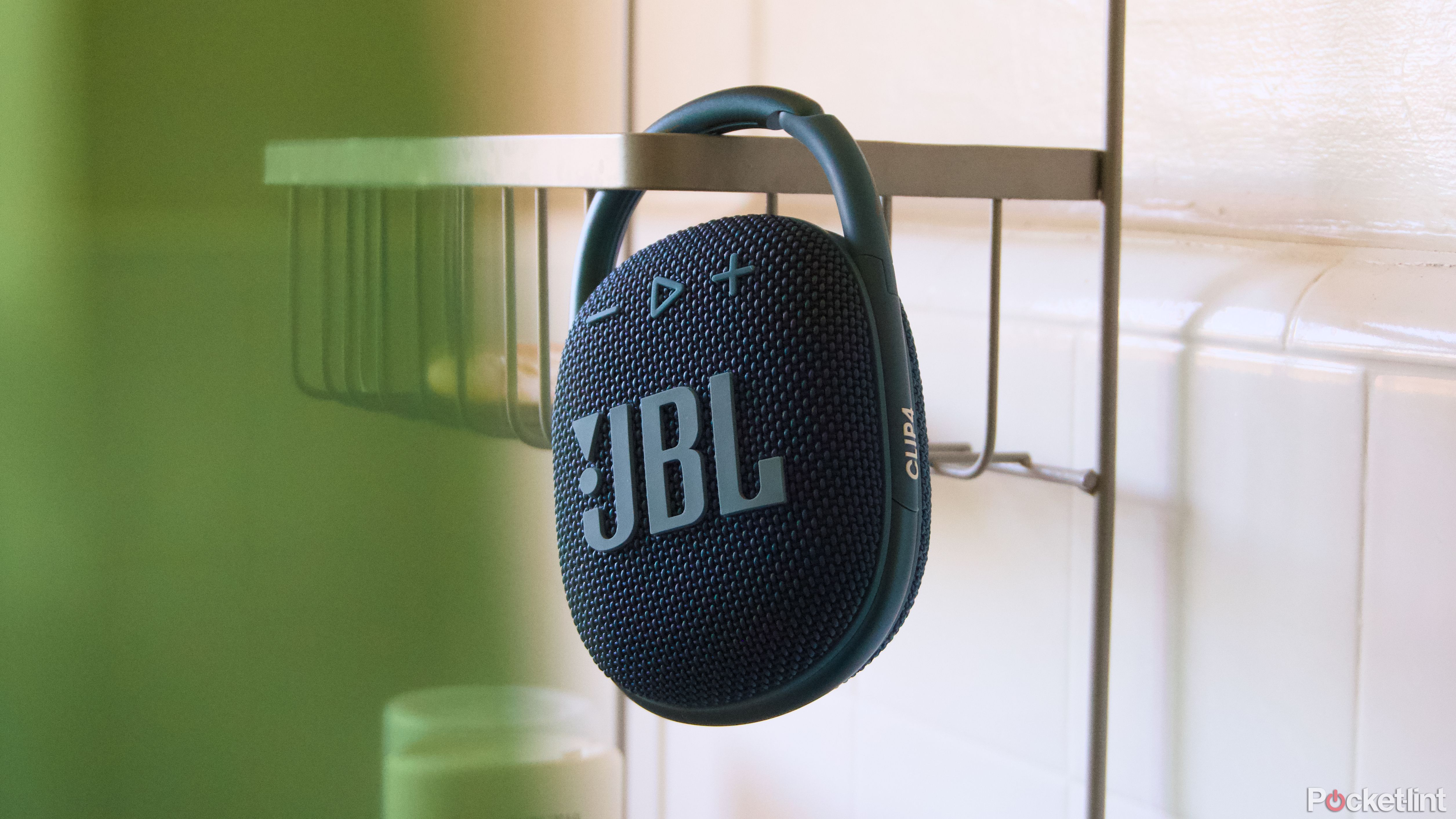 A JBL Clip 4 hanging in a shower.