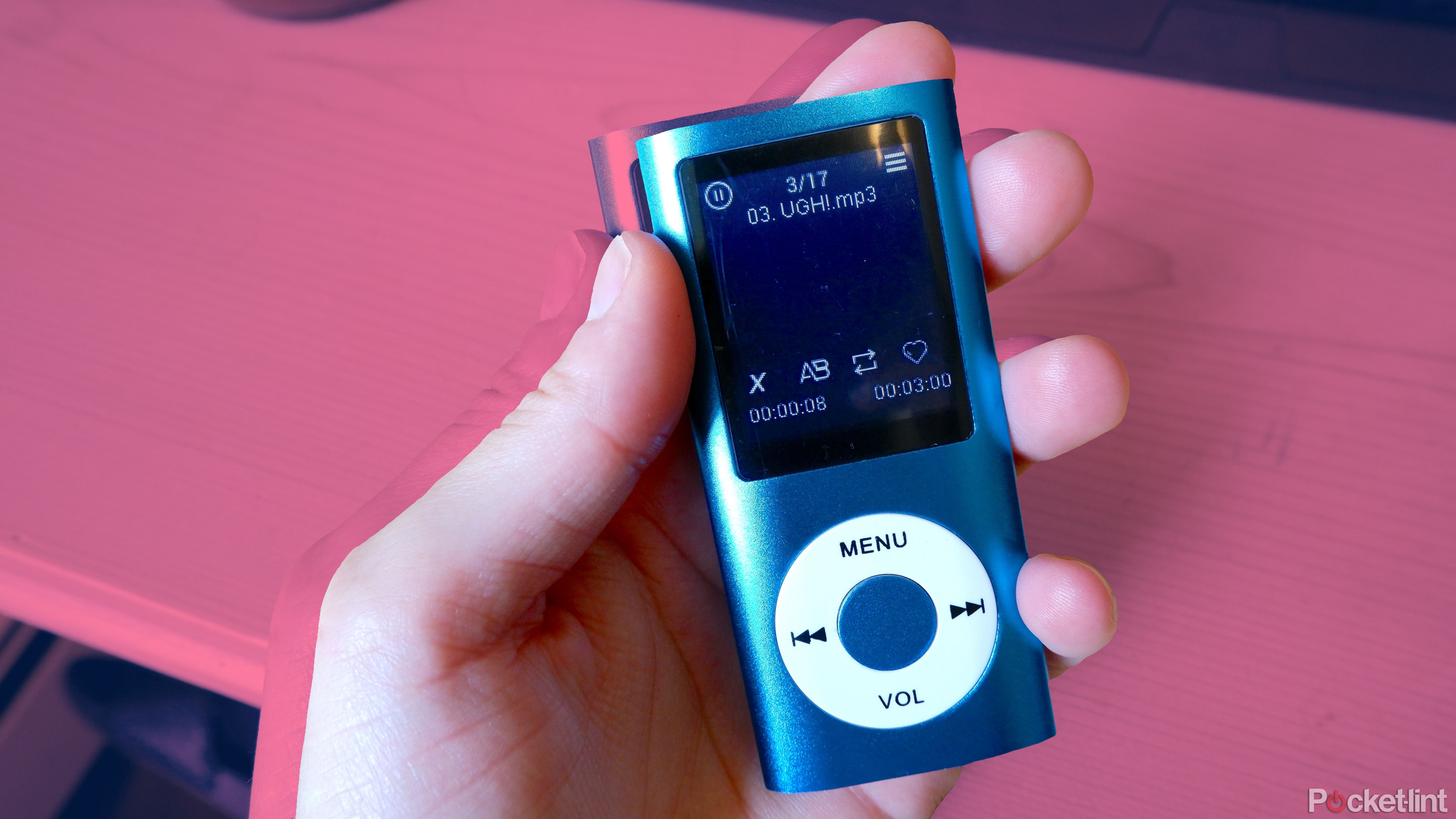 A hand holding a blue Luqeeg MP3 player