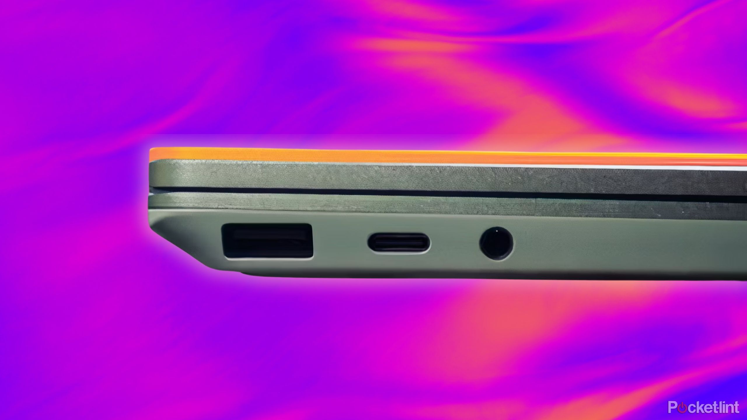 Laptop headphone jack and charging port against a purple and pink and orange background. 
