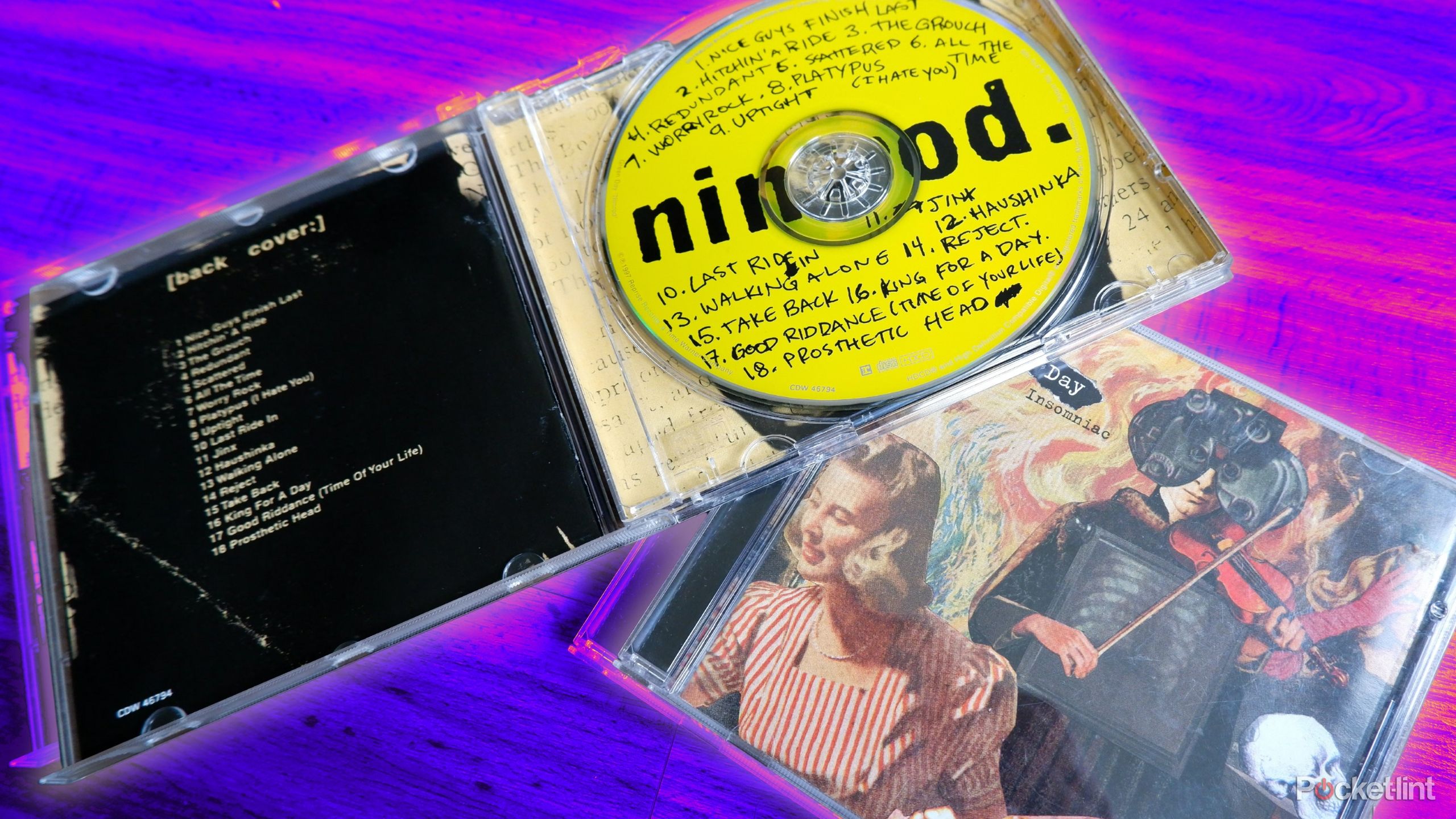 Two Green Day CD cases, one open and resting on top of the other.