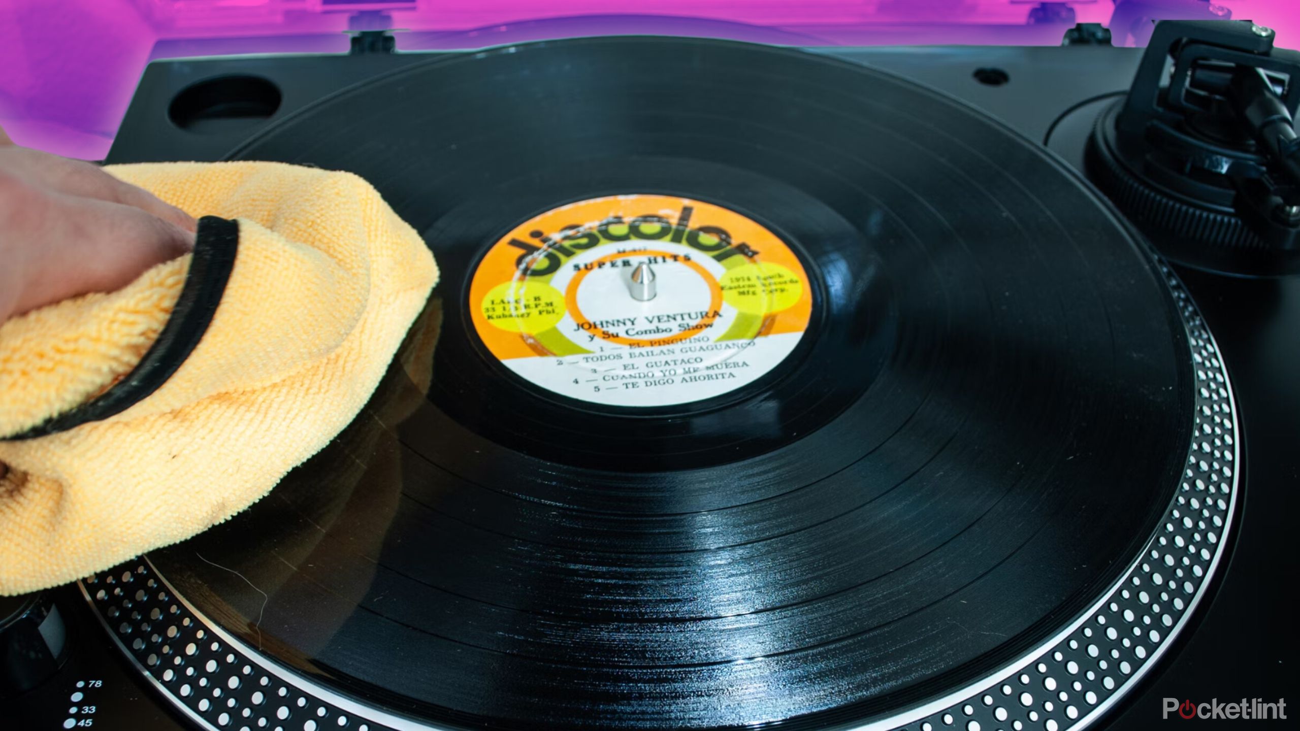 Someone wiping a vinyl with a microfiber towel. 