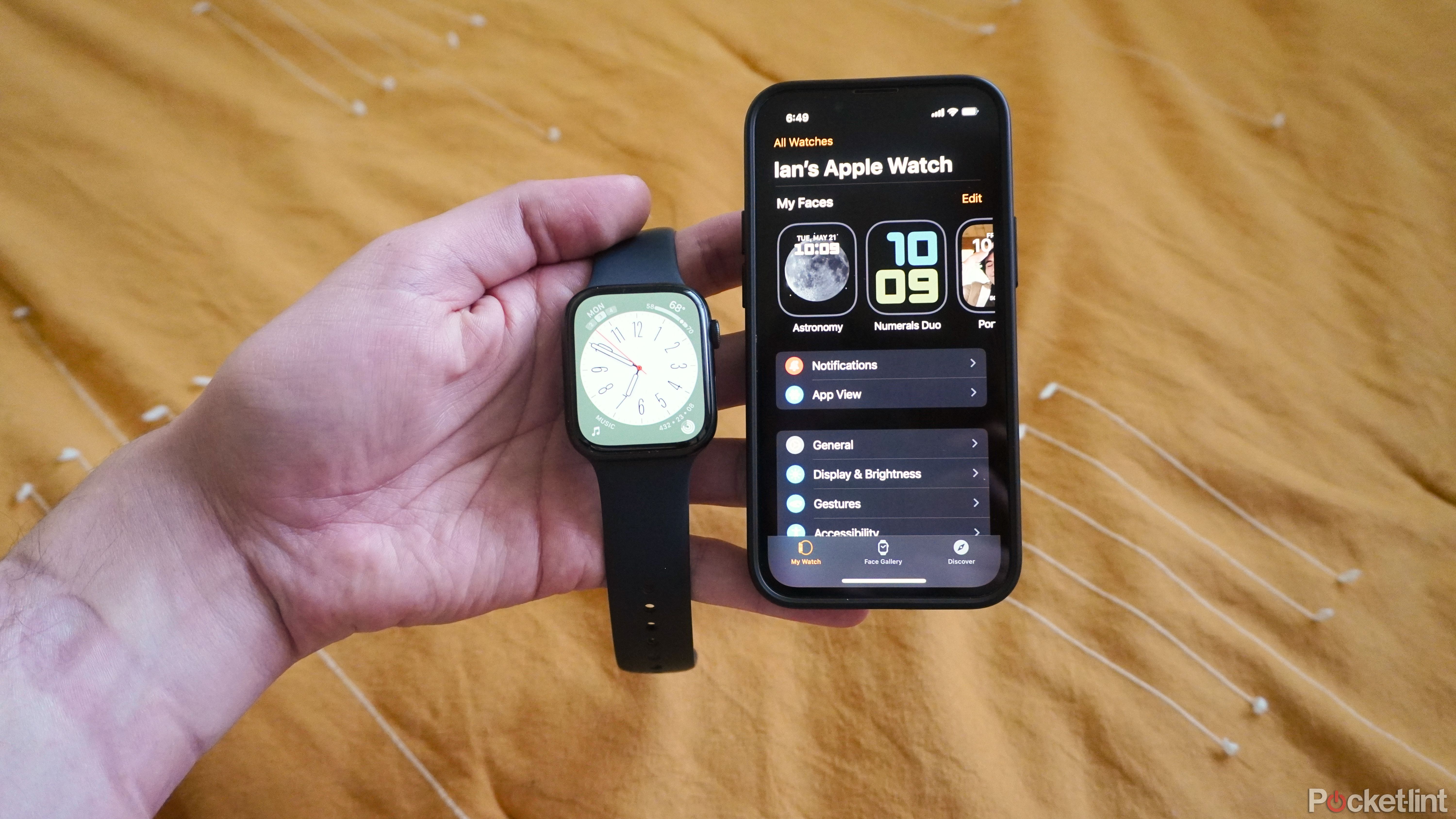 An Apple Watch Series 7 next to an iPhone 13 mini.