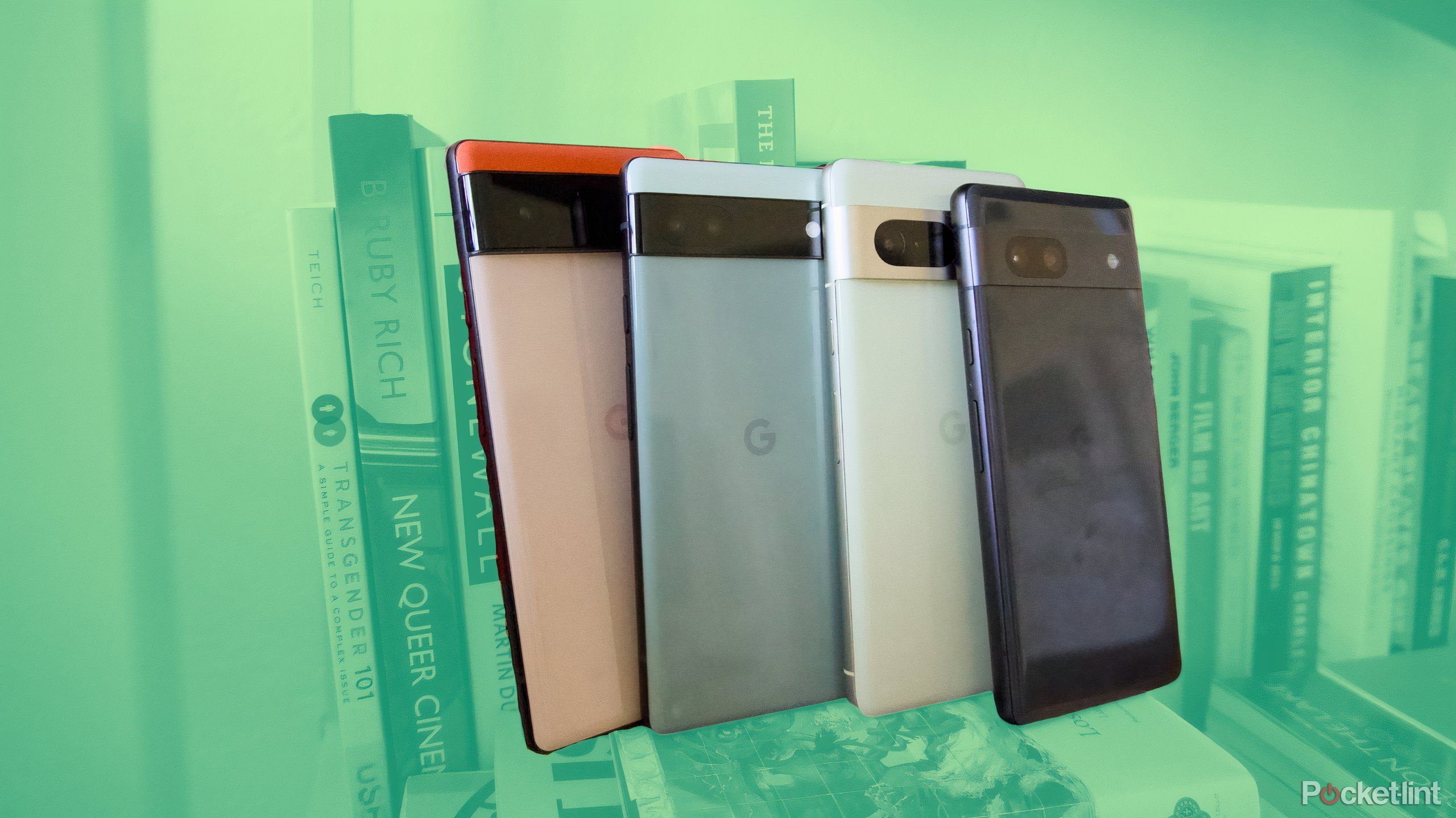A Pixel 6, Pixel 6a, Pixel 7, and Pixel 7a lined up and leaning against a shelf of books.