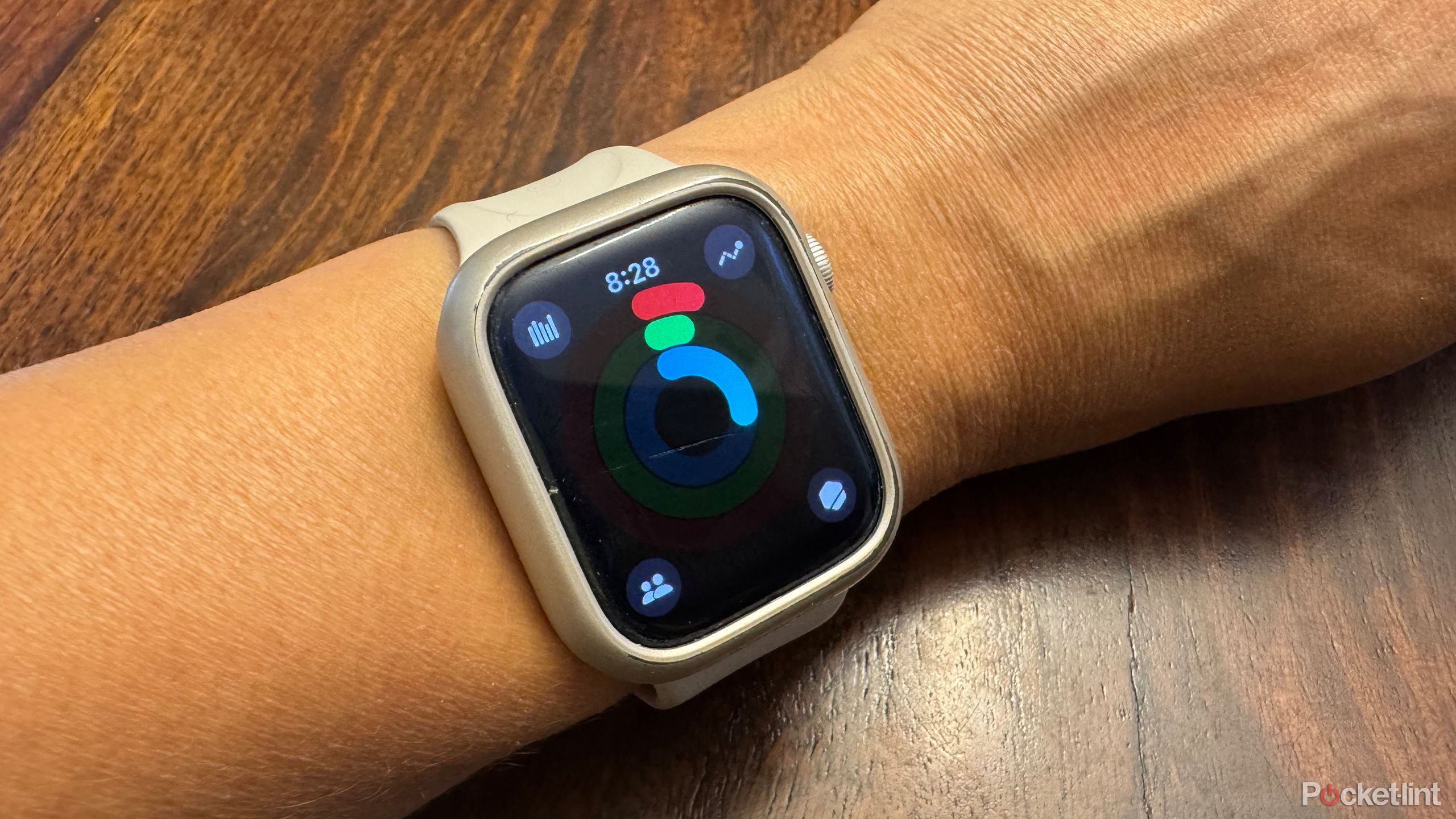 An Apple Watch on wrist showing Activity Goals and progress